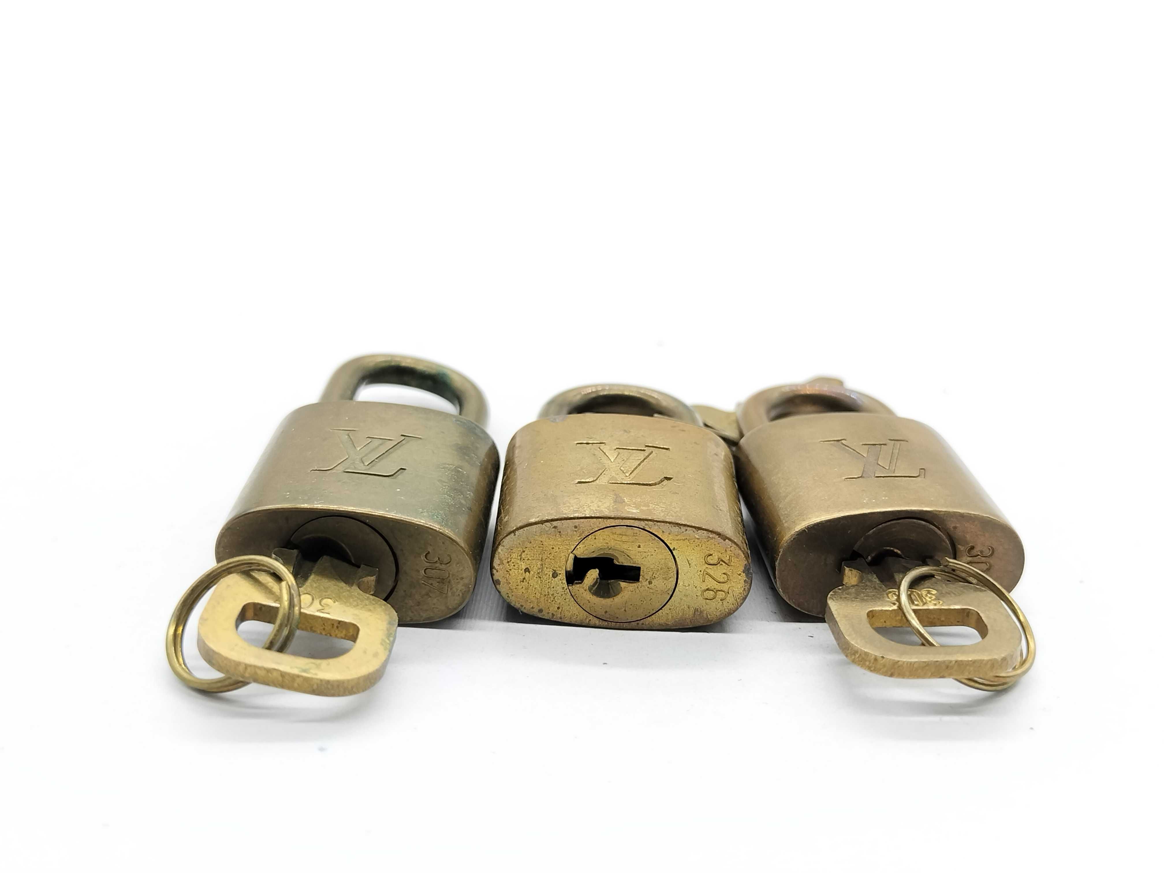 A Trio of Vintage Louis Vuitton Brass Luggage Padlocks with Matching Keys