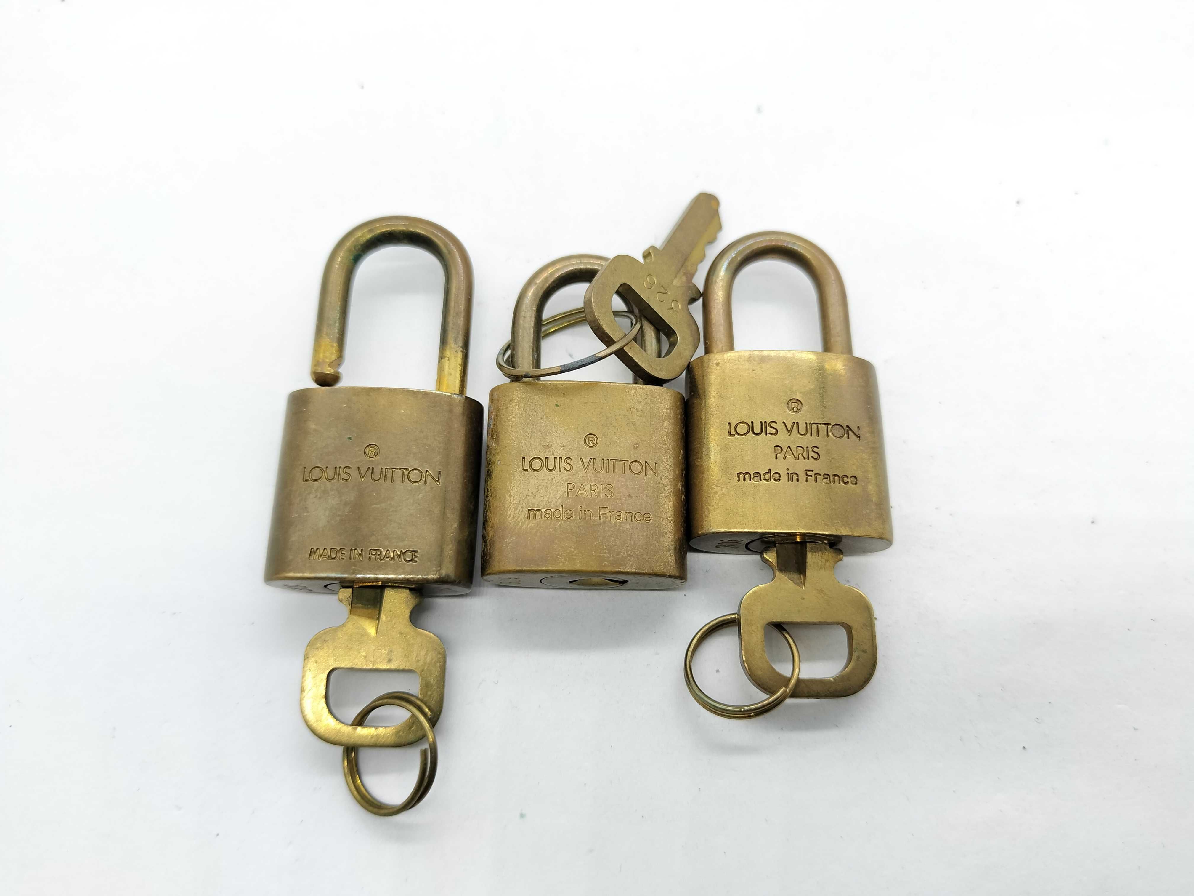 A Trio of Vintage Louis Vuitton Brass Luggage Padlocks with Matching Keys