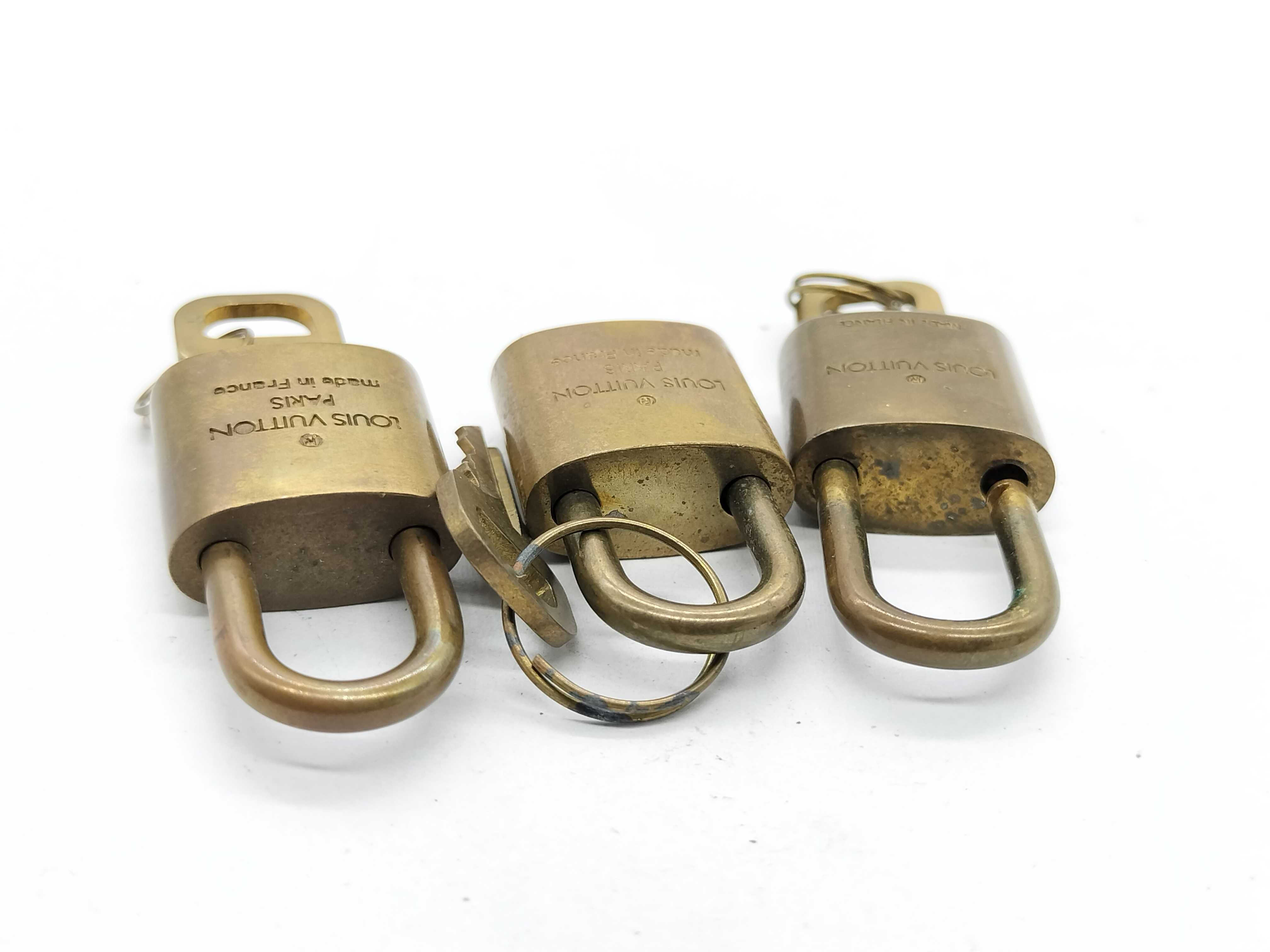 A Trio of Vintage Louis Vuitton Brass Luggage Padlocks with Matching Keys