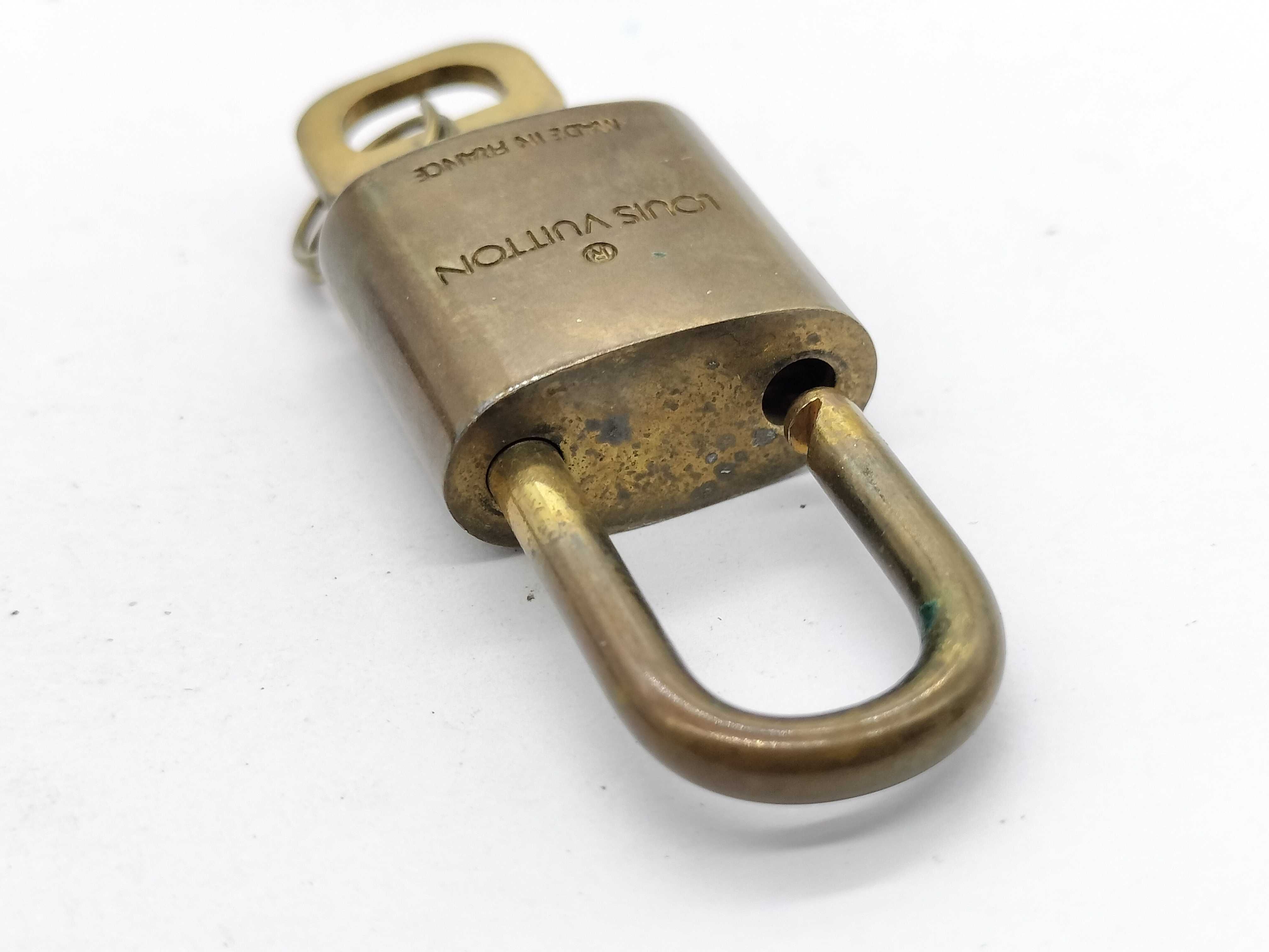 A Trio of Vintage Louis Vuitton Brass Luggage Padlocks with Matching Keys