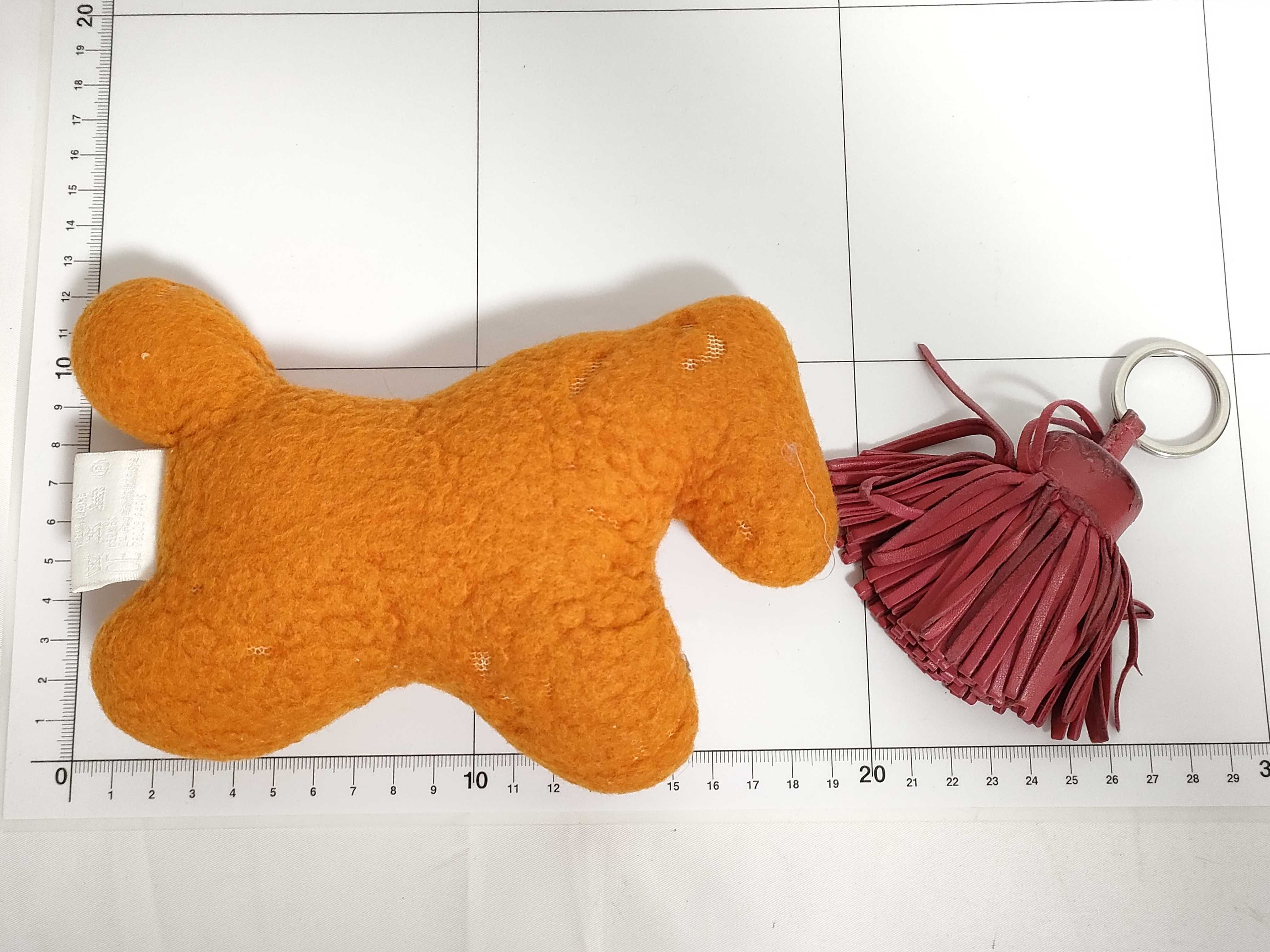 Two Hermès Accessories, Orange El Peluche Horse Plush and Burgundy Carmen Tassel Keychain