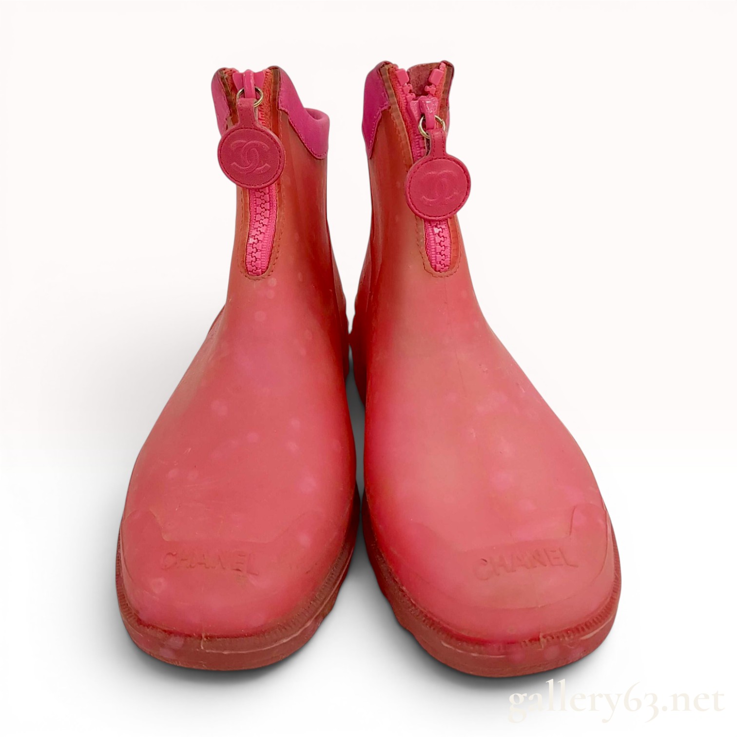 A Pair of Chanel Pink Polka Dot Translucent Rubber Front Zip Ankle Rain Boots Size 38