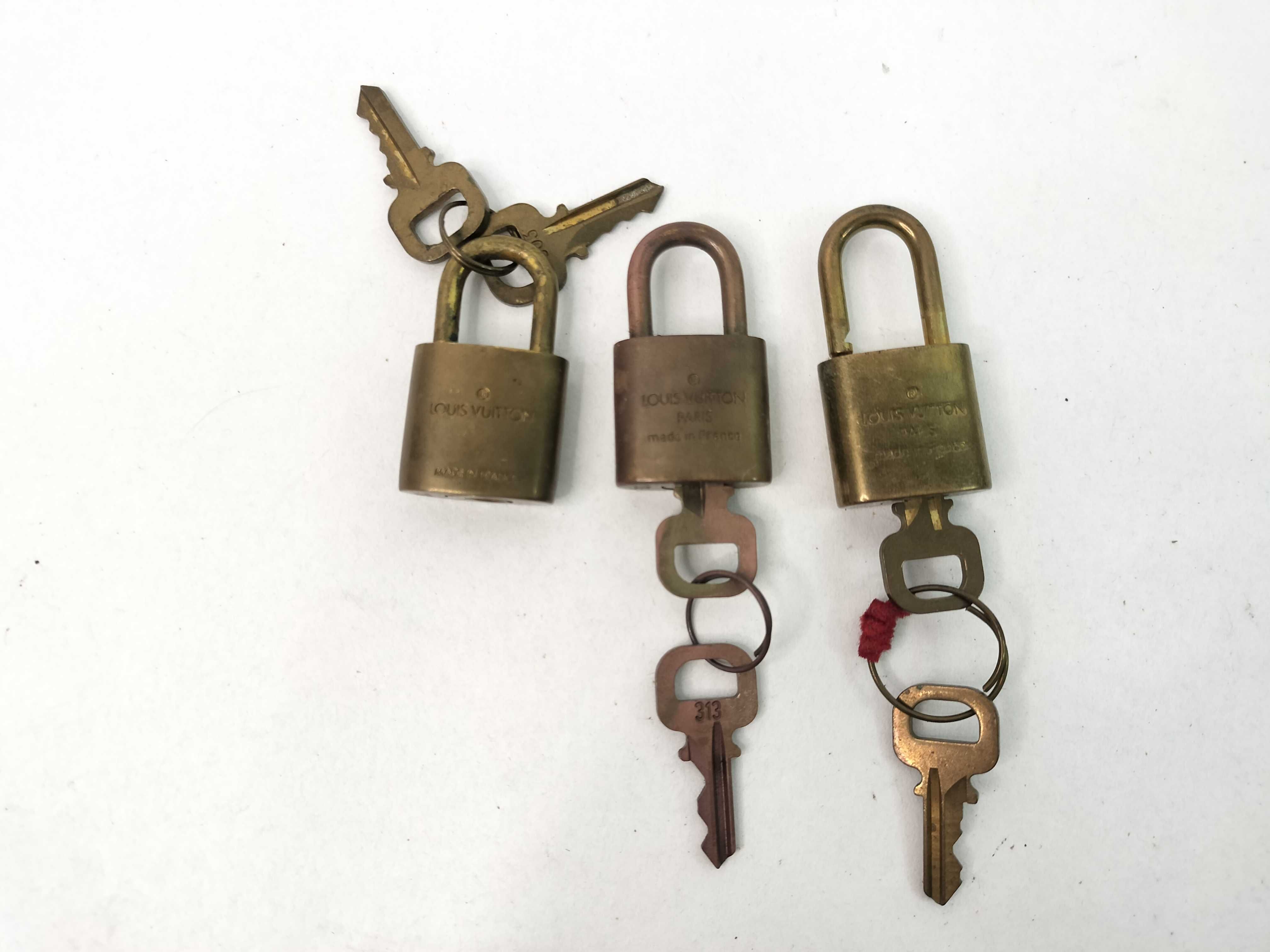 A Trio of Louis Vuitton Brass Padlocks and Keys