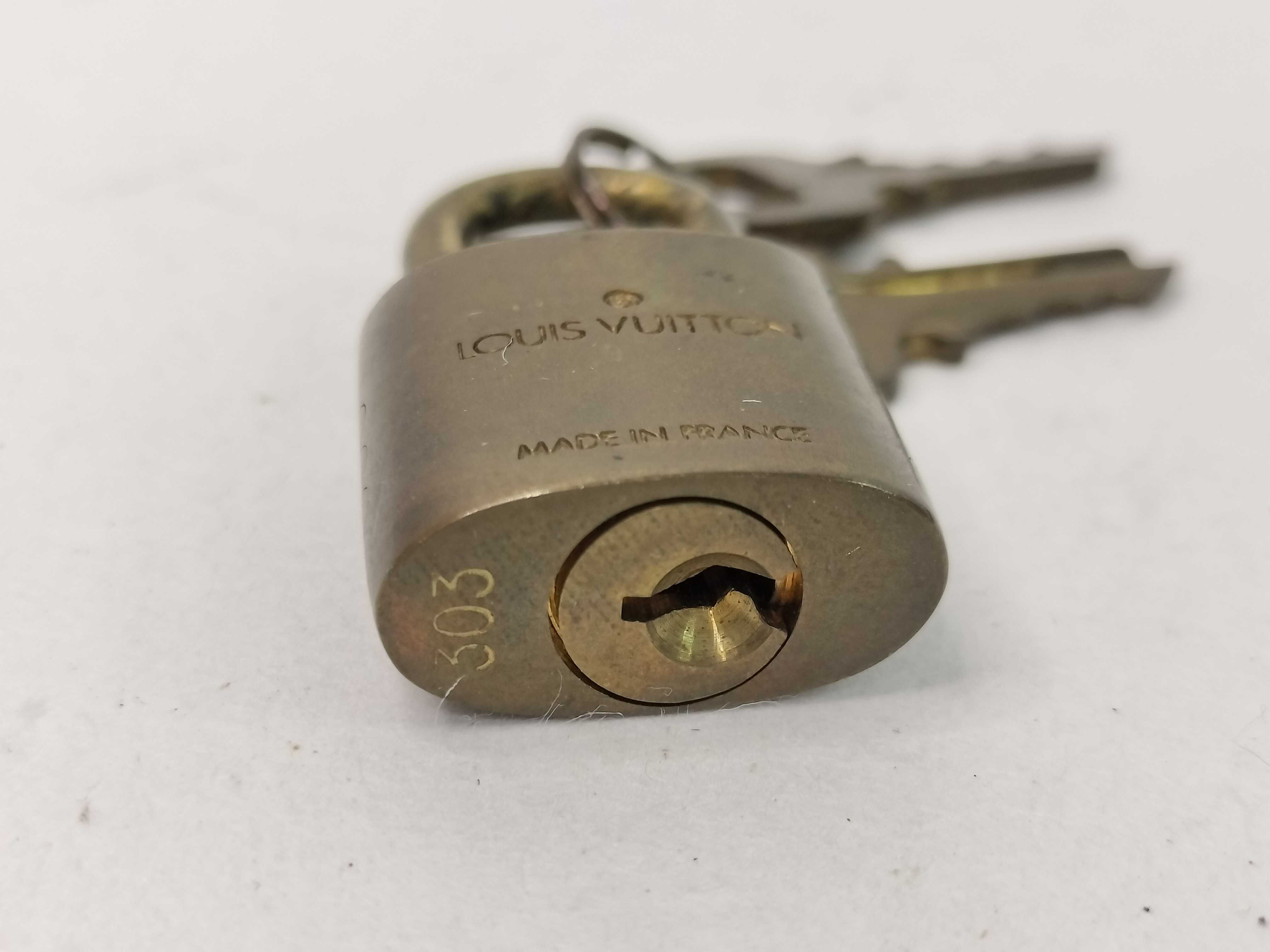 A Trio of Louis Vuitton Brass Padlocks and Keys
