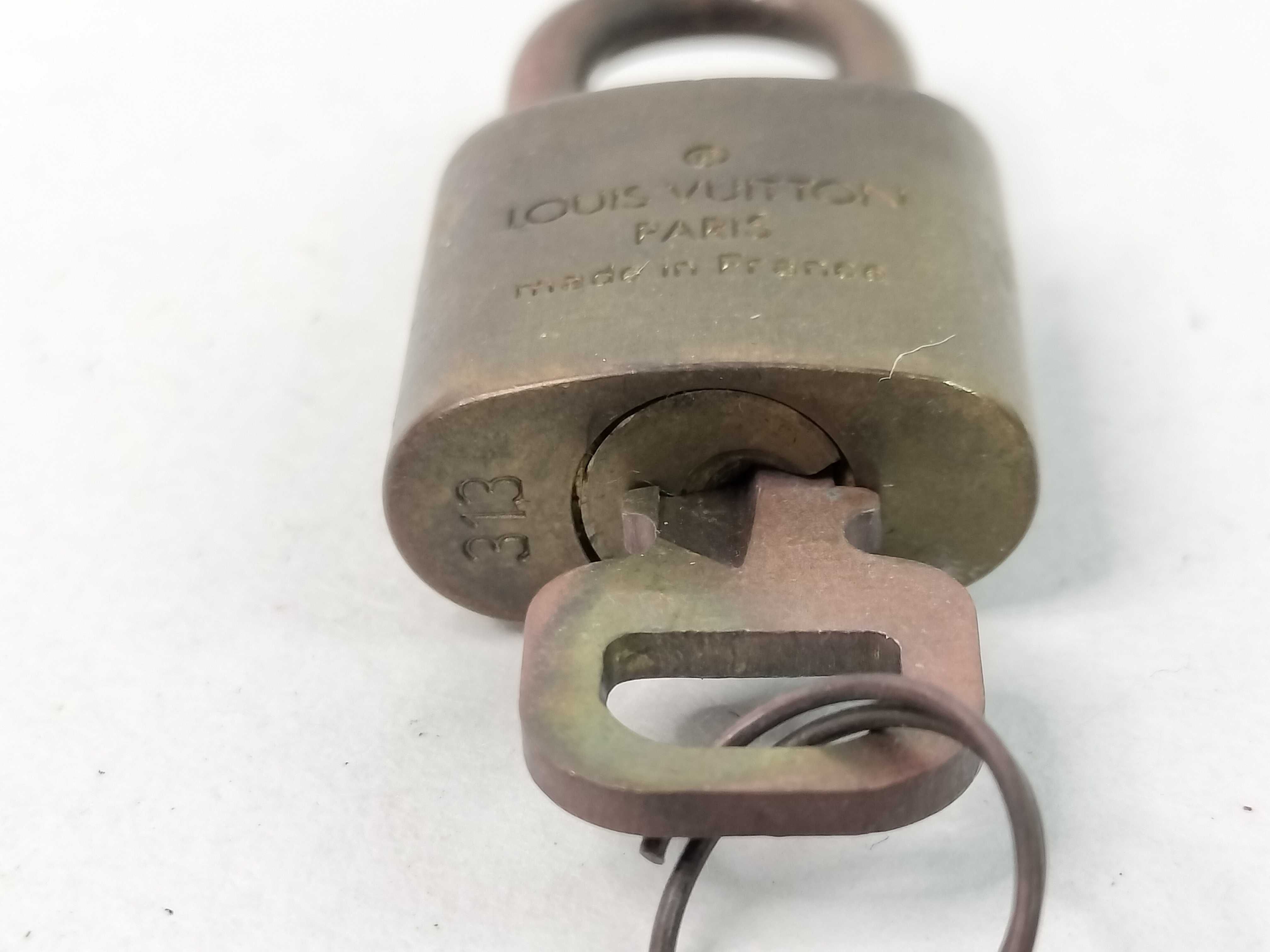 A Trio of Louis Vuitton Brass Padlocks and Keys