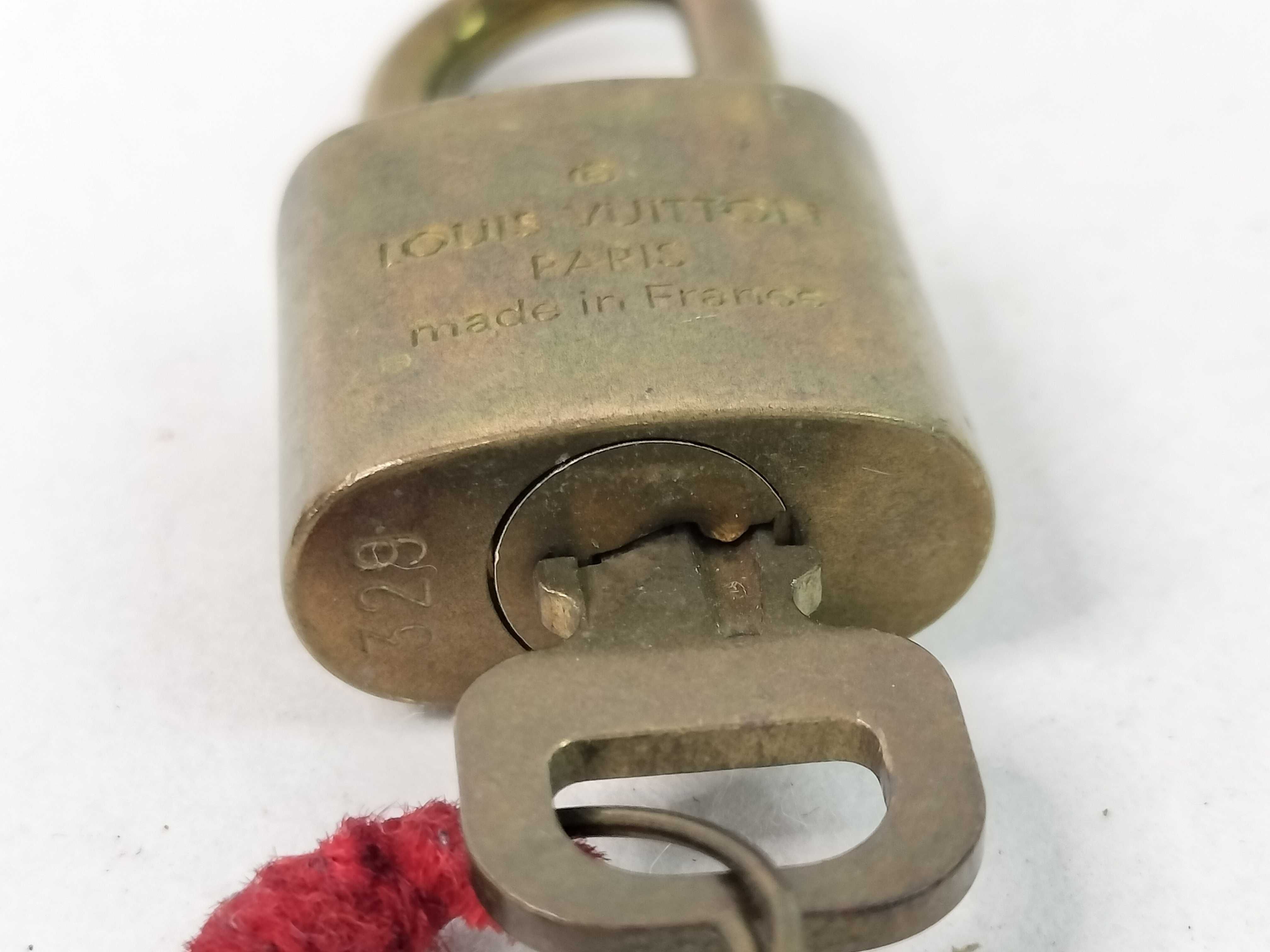 A Trio of Louis Vuitton Brass Padlocks and Keys
