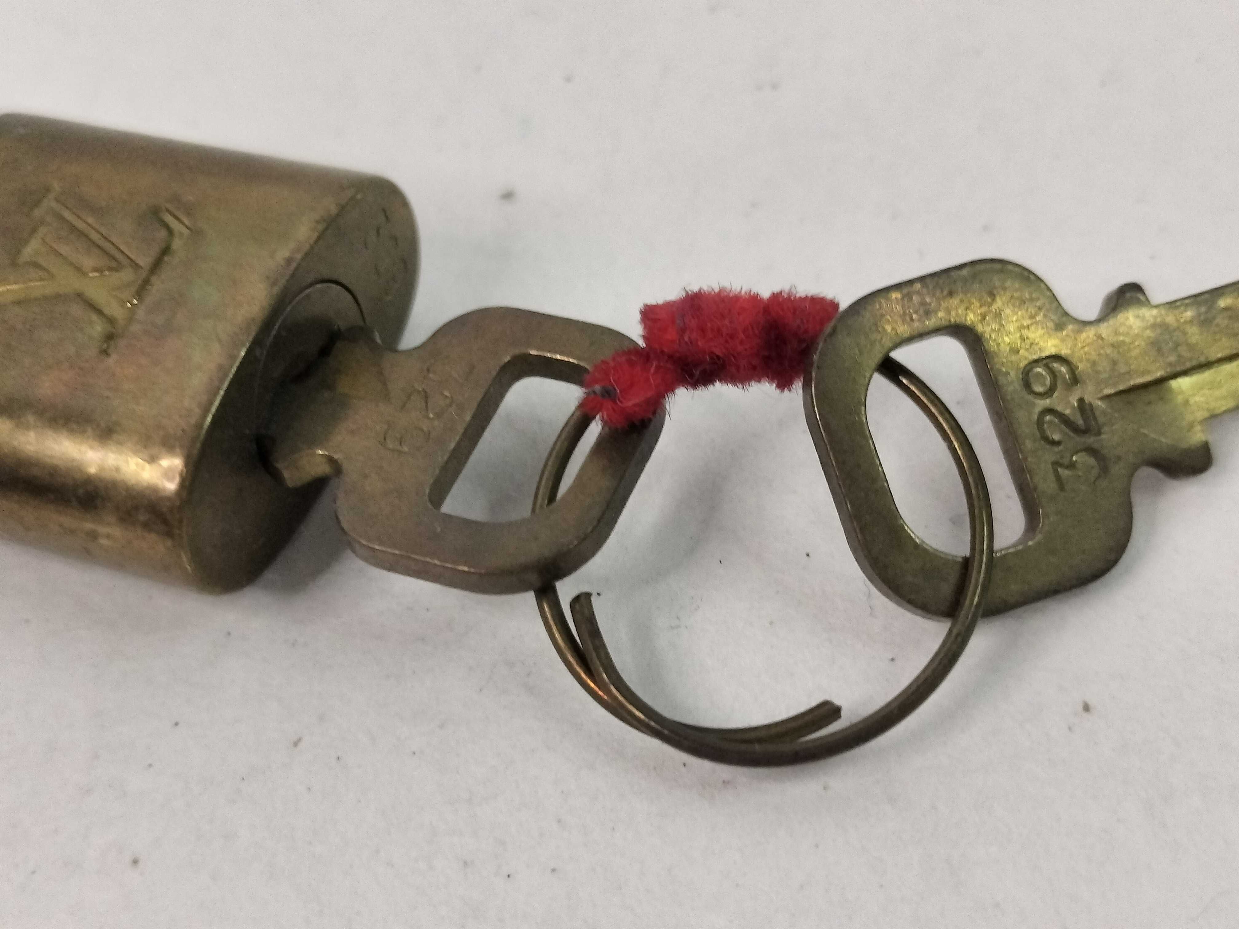 A Trio of Louis Vuitton Brass Padlocks and Keys