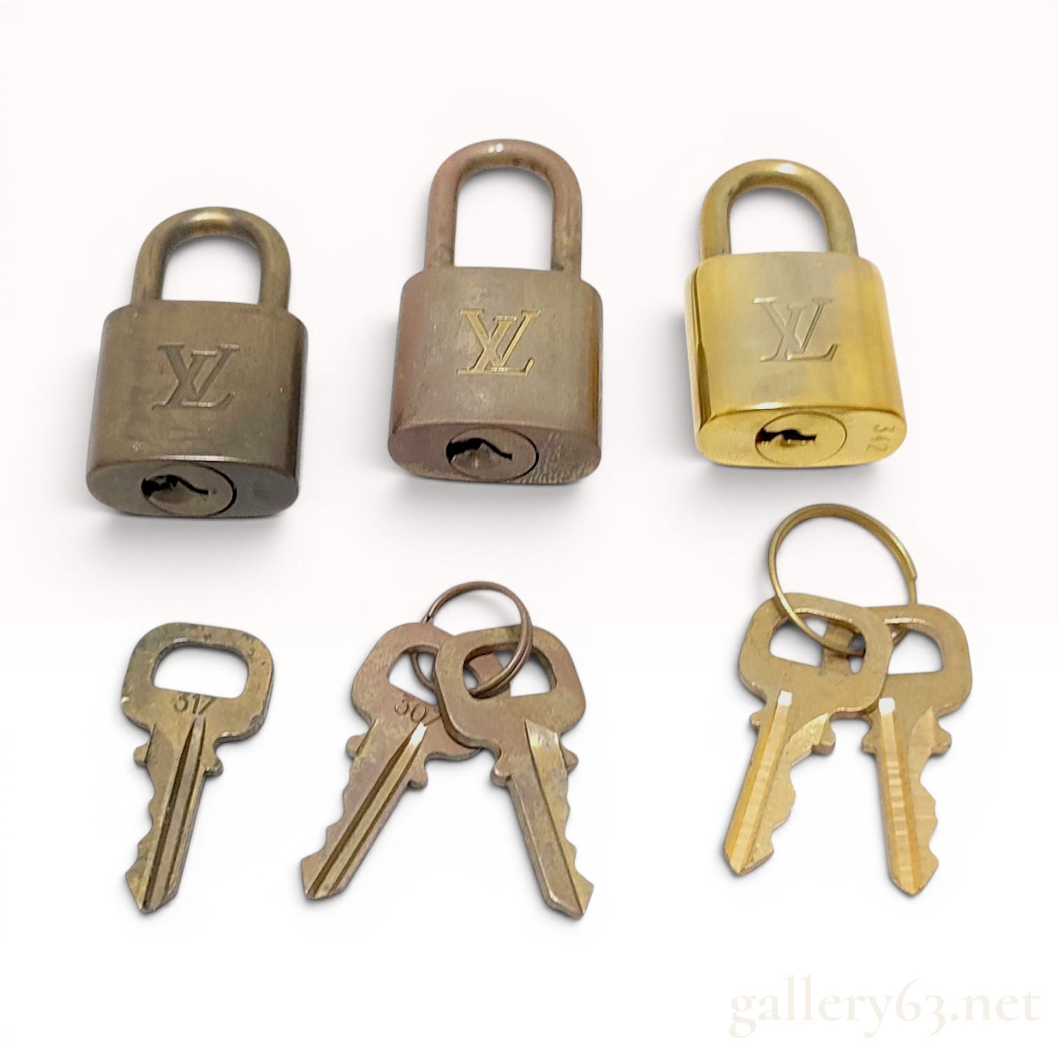 A Trio of Authentic Louis Vuitton Brass Padlocks with Keys