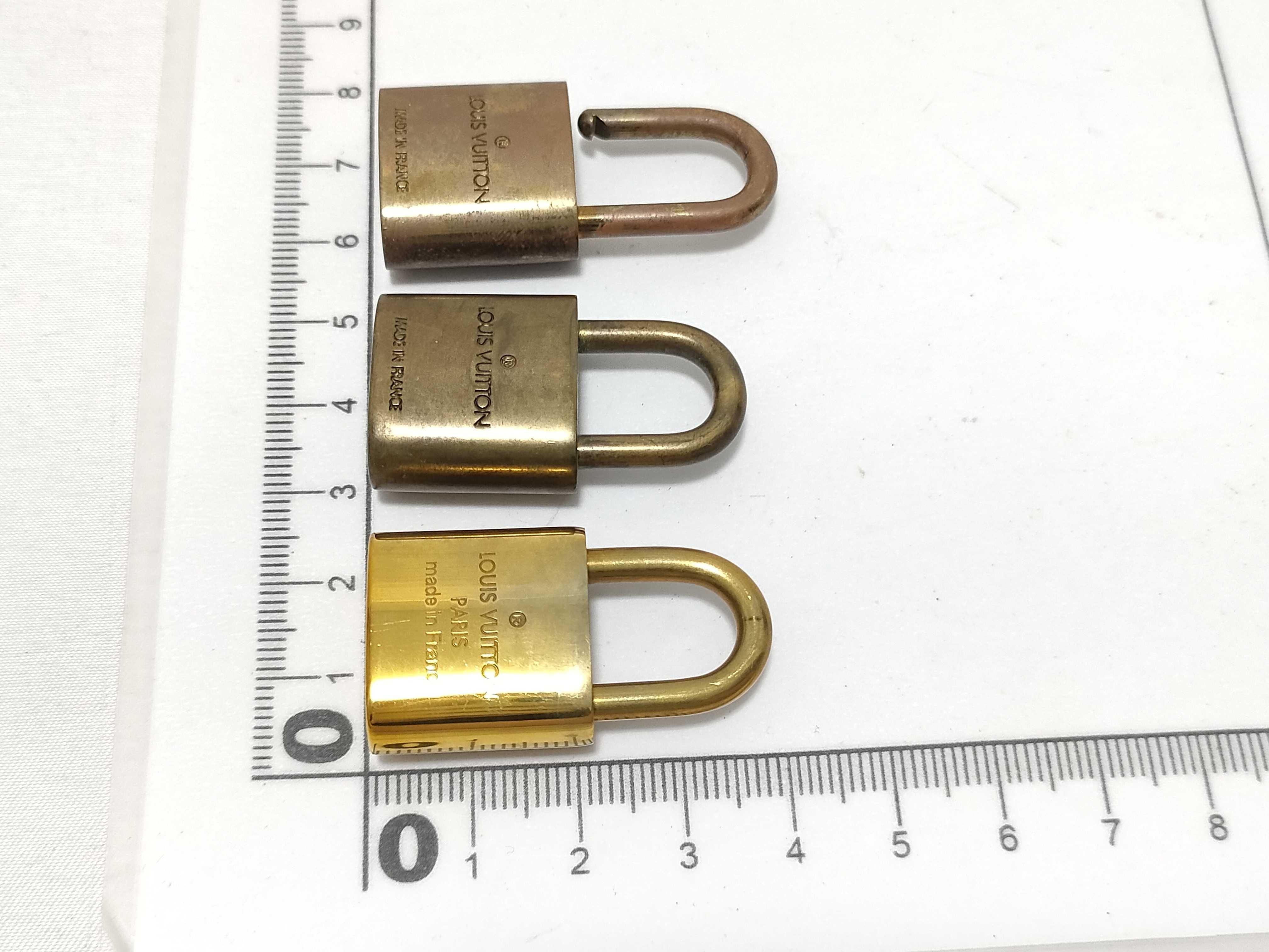 A Trio of Authentic Louis Vuitton Brass Padlocks with Keys