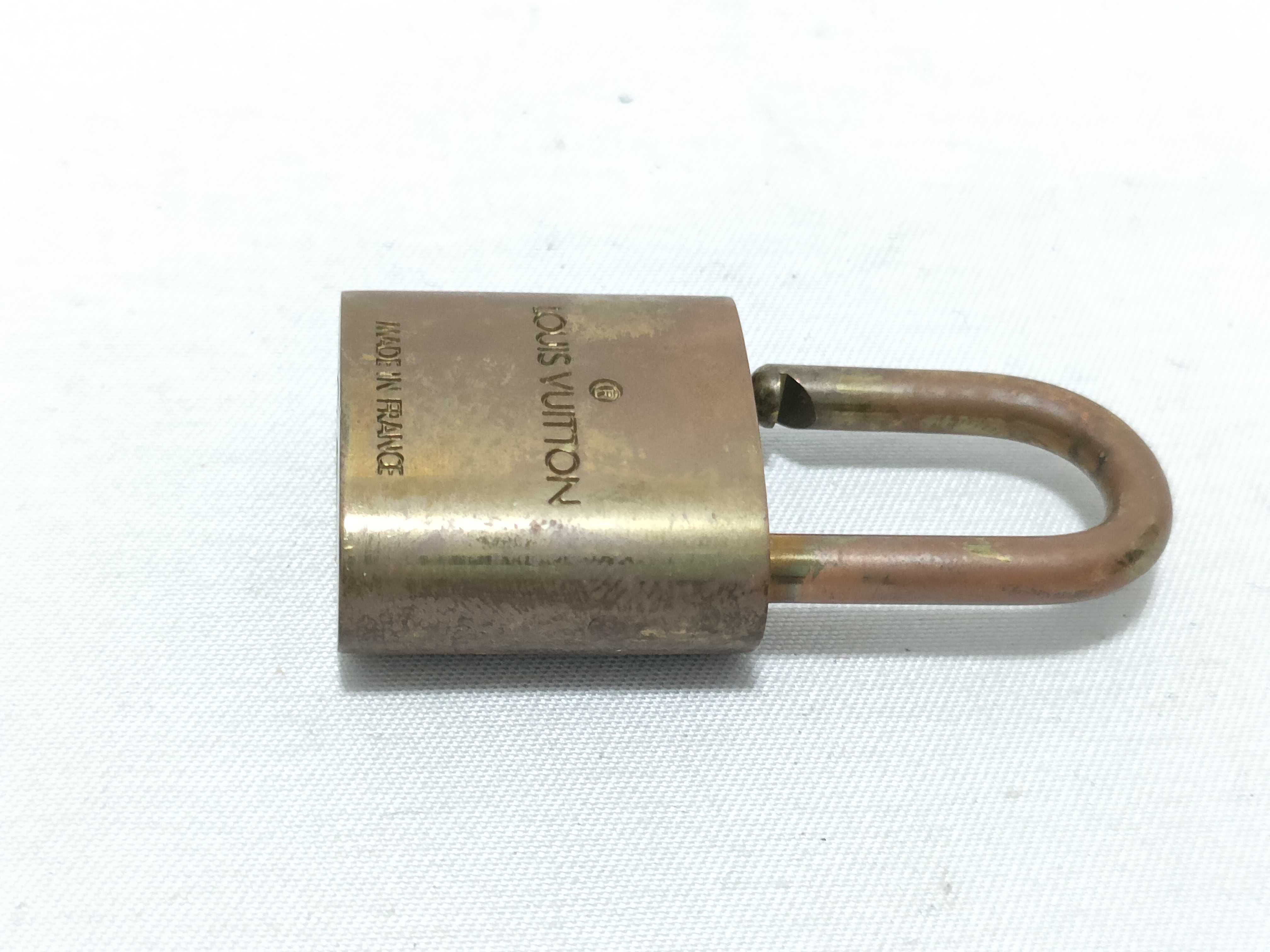 A Trio of Authentic Louis Vuitton Brass Padlocks with Keys