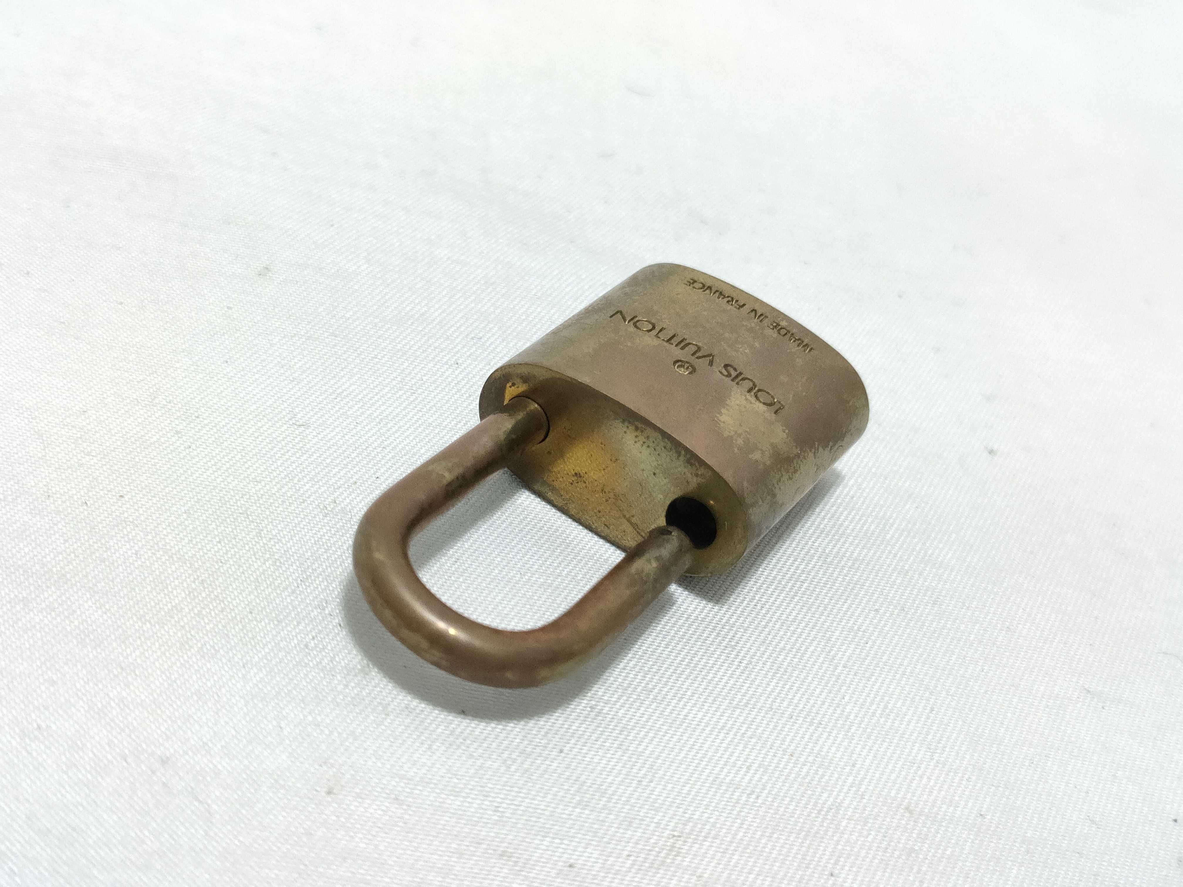 A Trio of Authentic Louis Vuitton Brass Padlocks with Keys