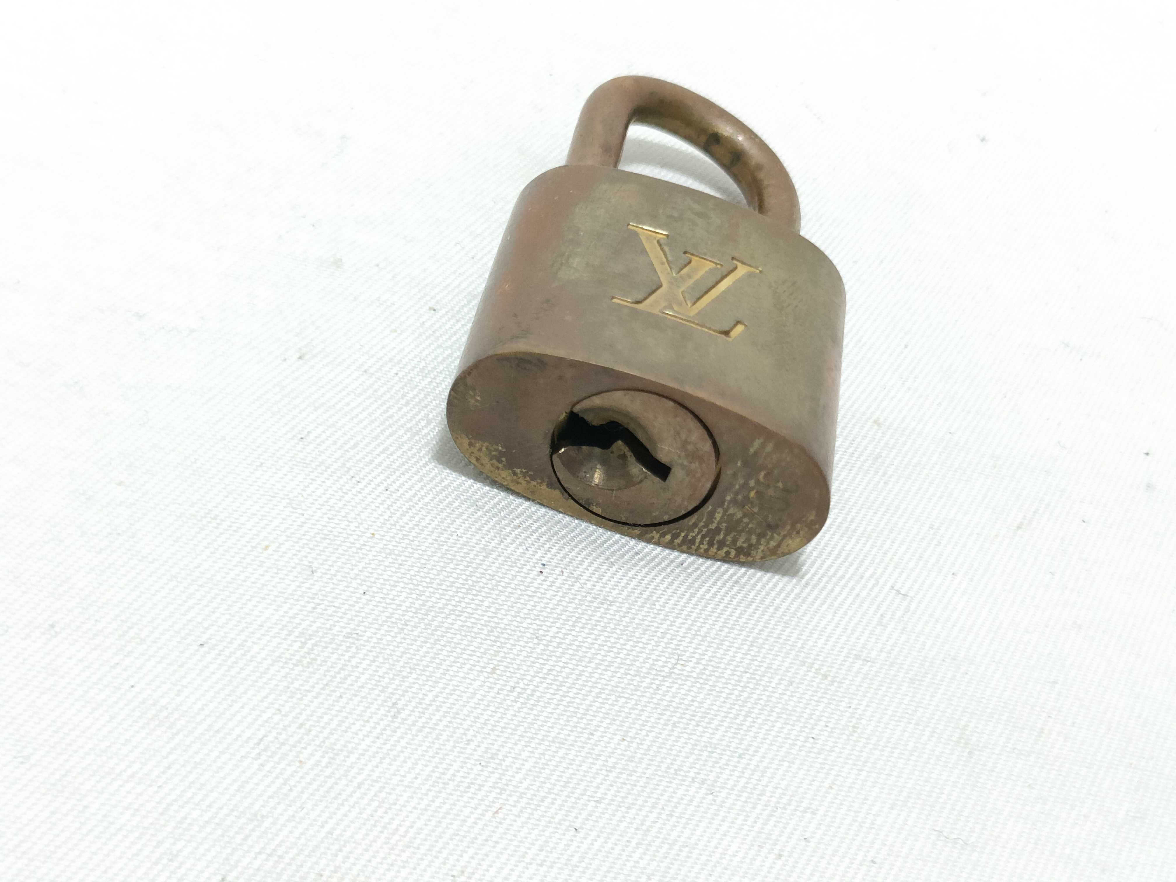 A Trio of Authentic Louis Vuitton Brass Padlocks with Keys