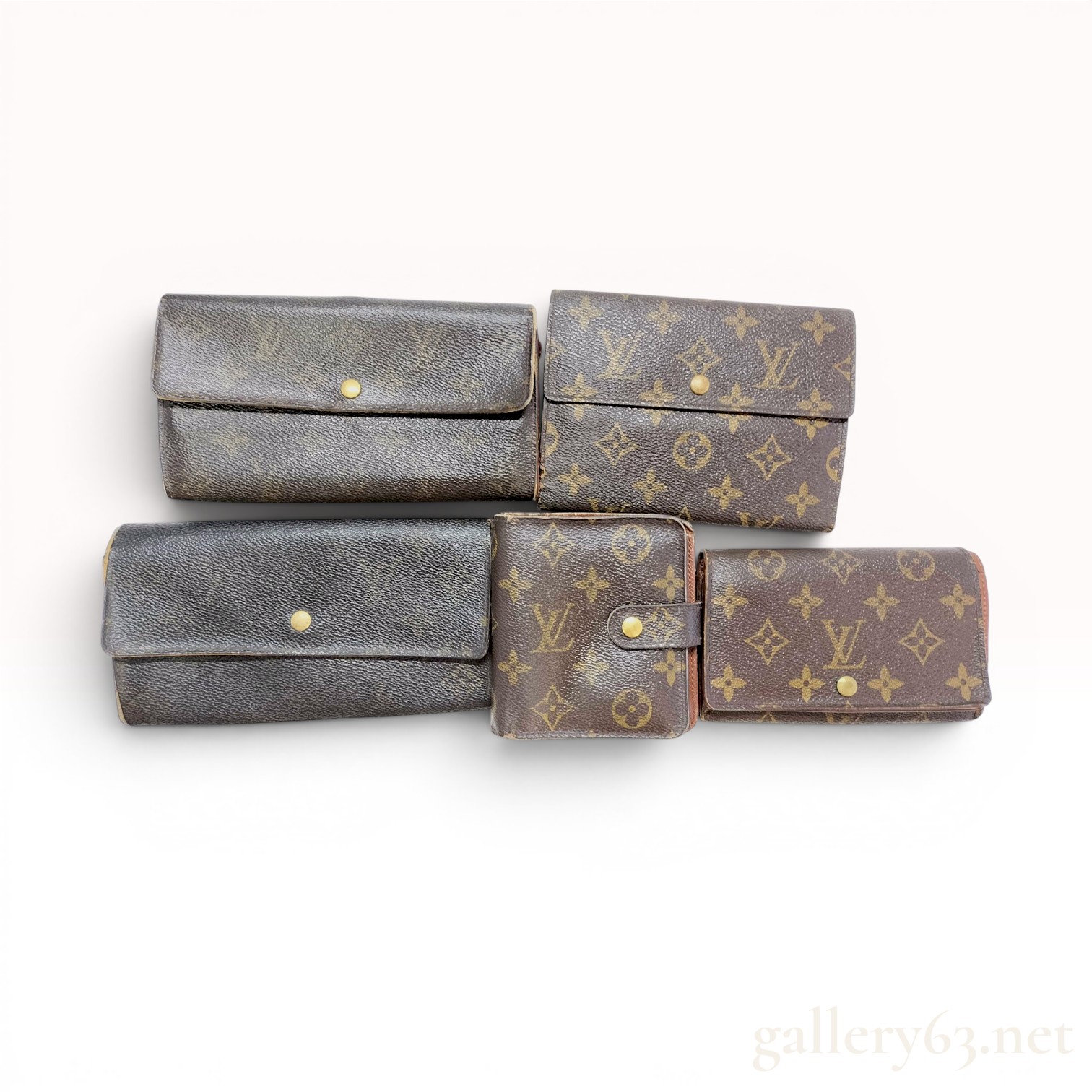 A Collection of Five Louis Vuitton Monogram Coated Canvas Wallets
