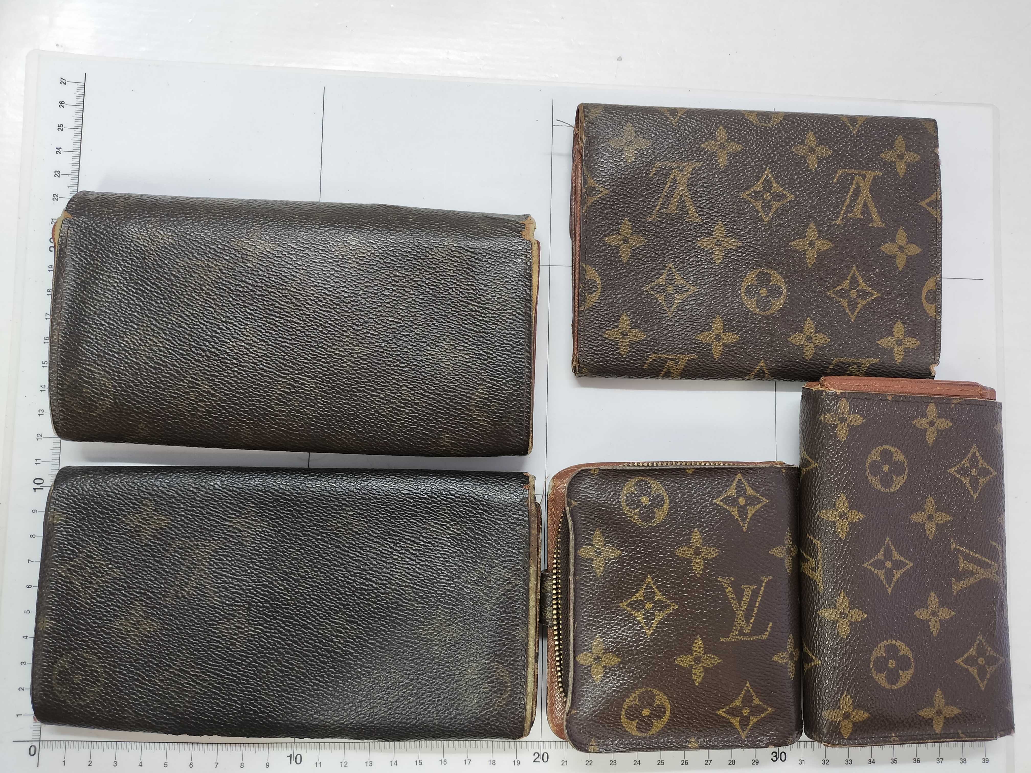 A Collection of Five Louis Vuitton Monogram Coated Canvas Wallets
