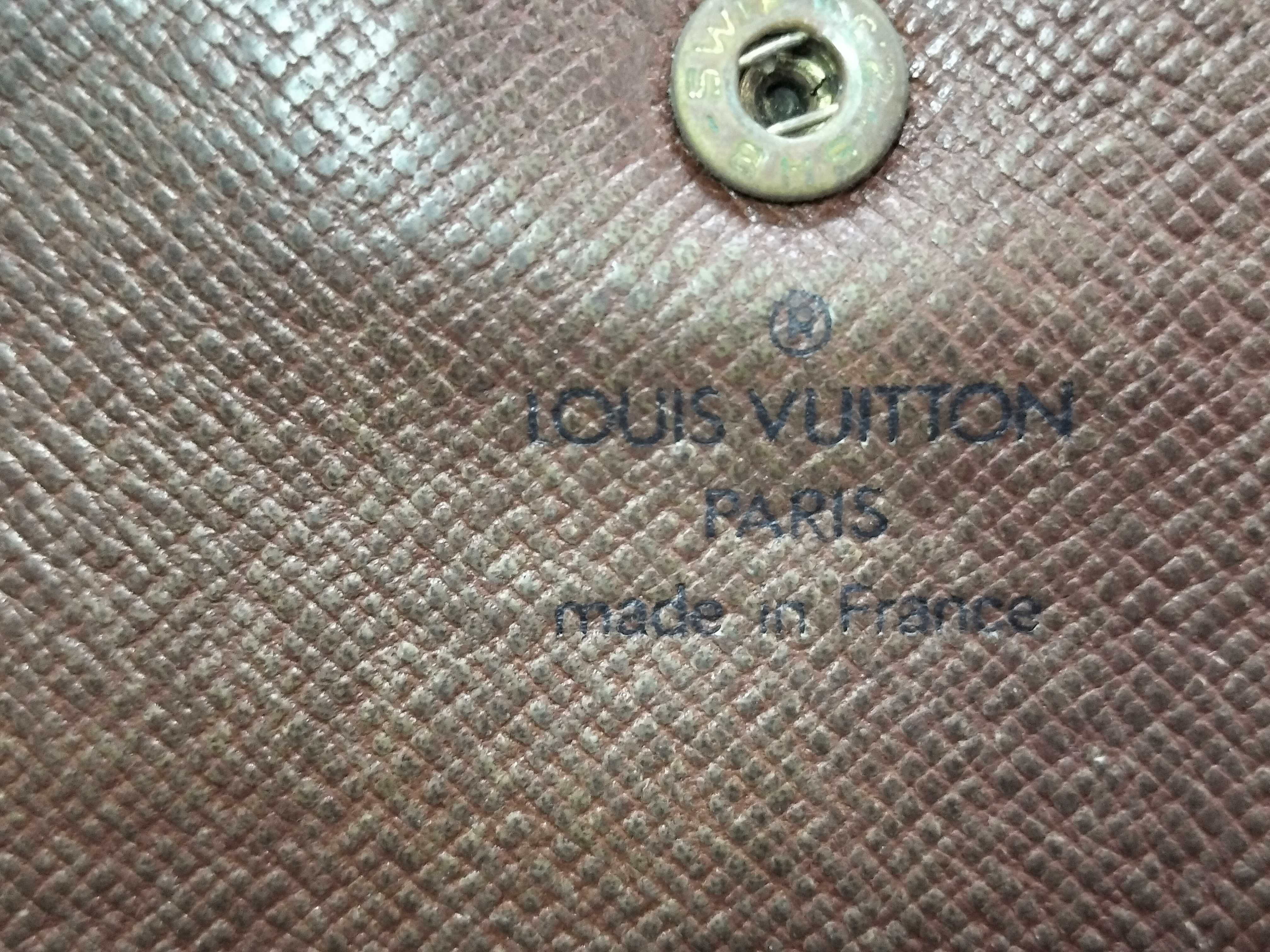 A Collection of Five Louis Vuitton Monogram Coated Canvas Wallets