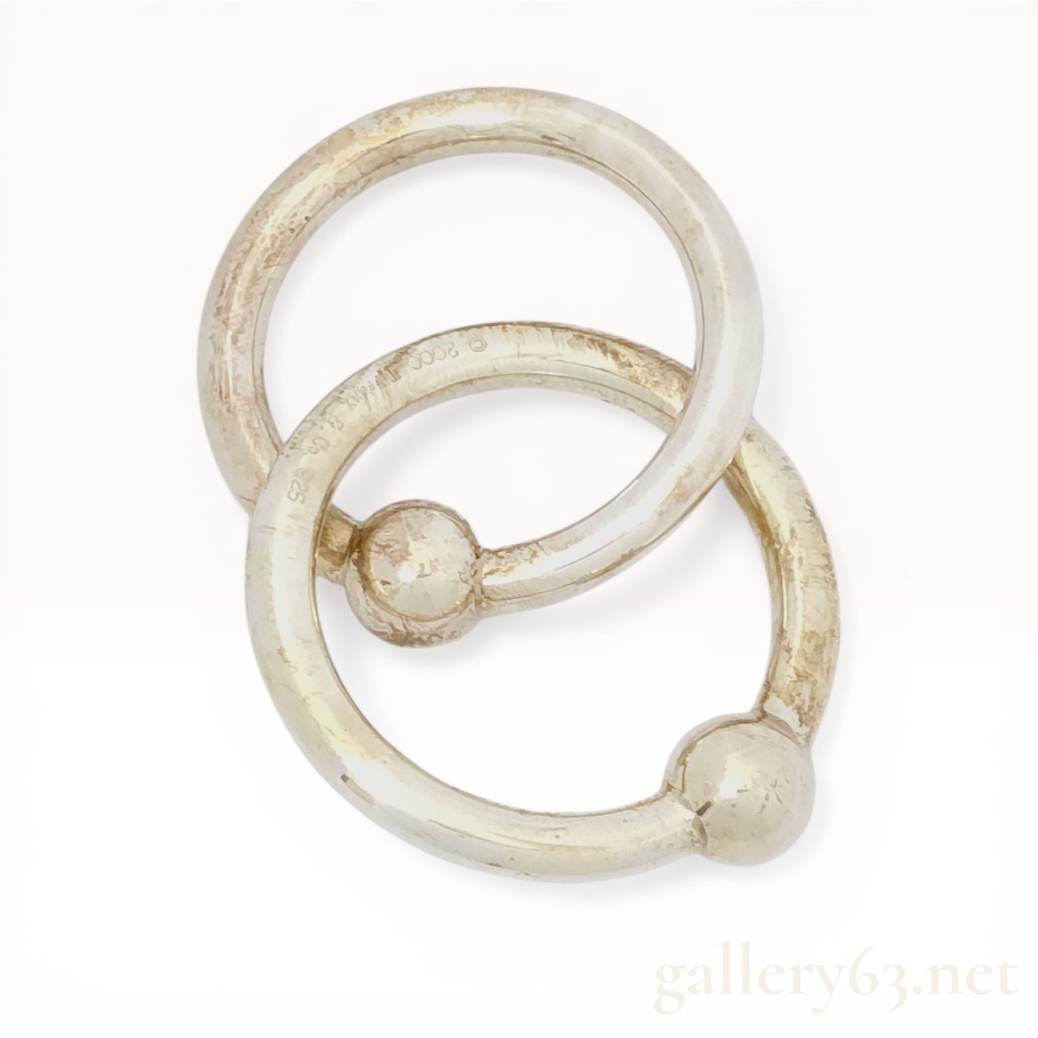 A Pair of Tiffany and Co. Sterling Silver Interlocking Baby Teething Rings