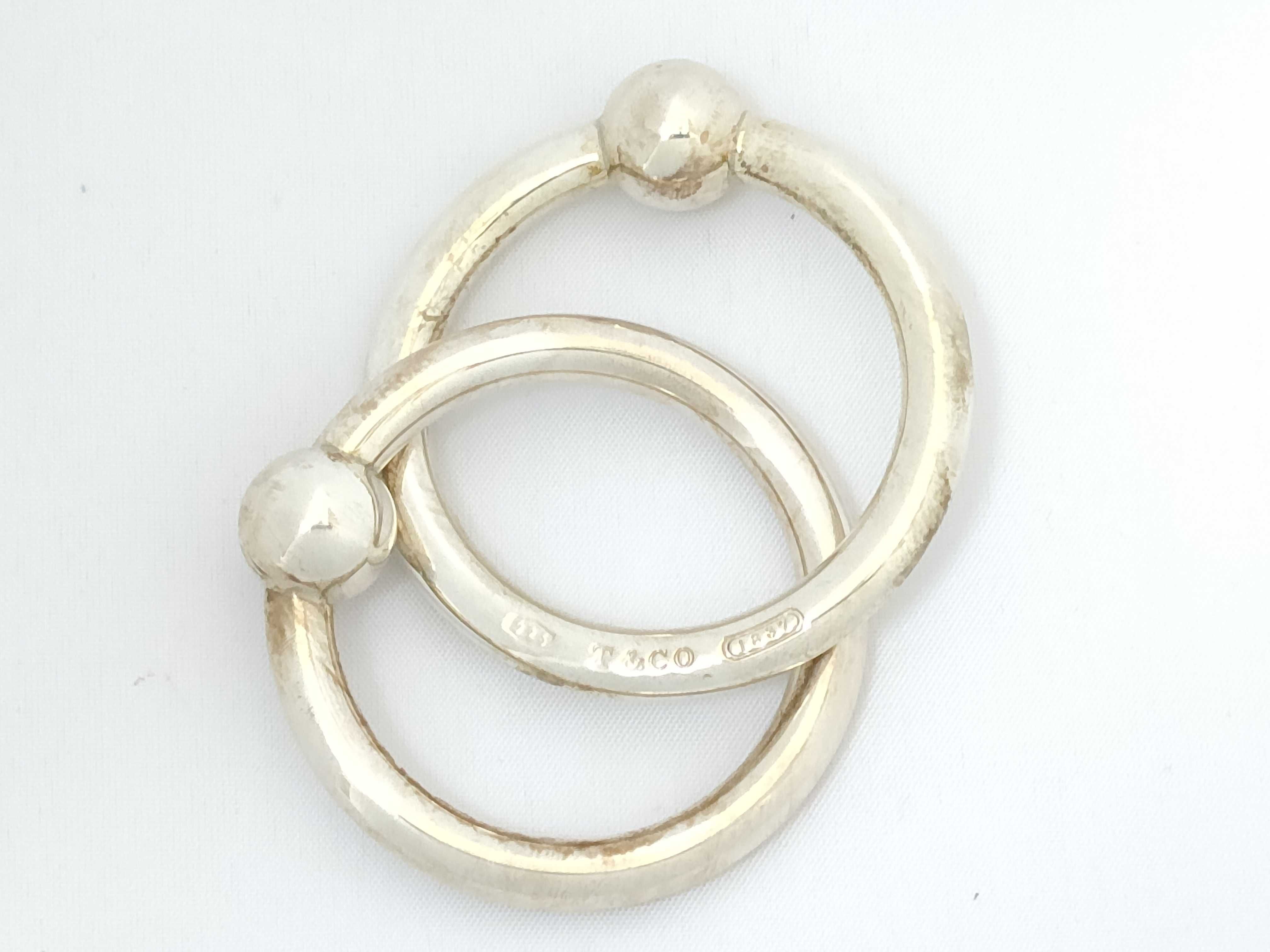 A Pair of Tiffany and Co. Sterling Silver Interlocking Baby Teething Rings
