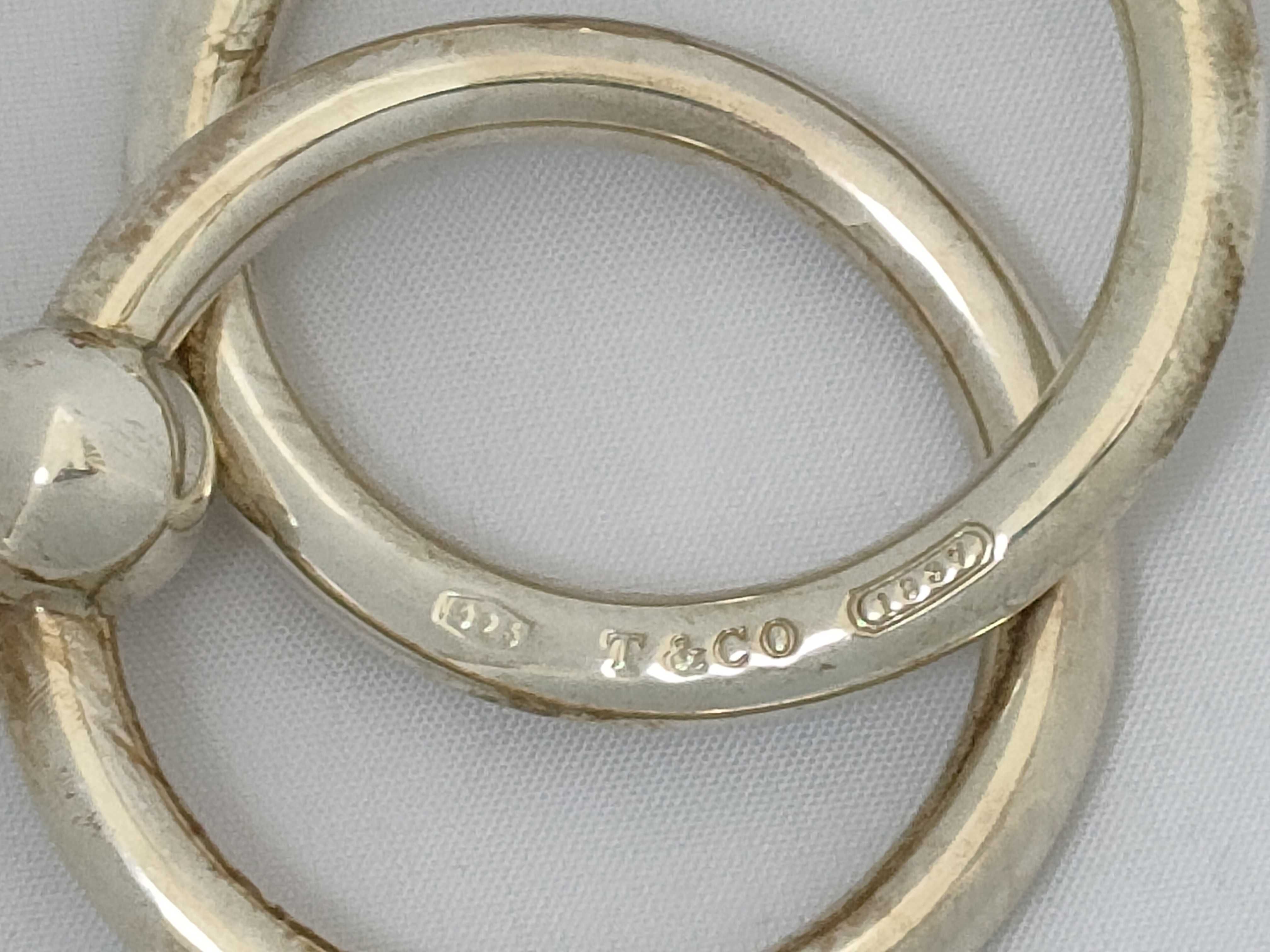 A Pair of Tiffany and Co. Sterling Silver Interlocking Baby Teething Rings