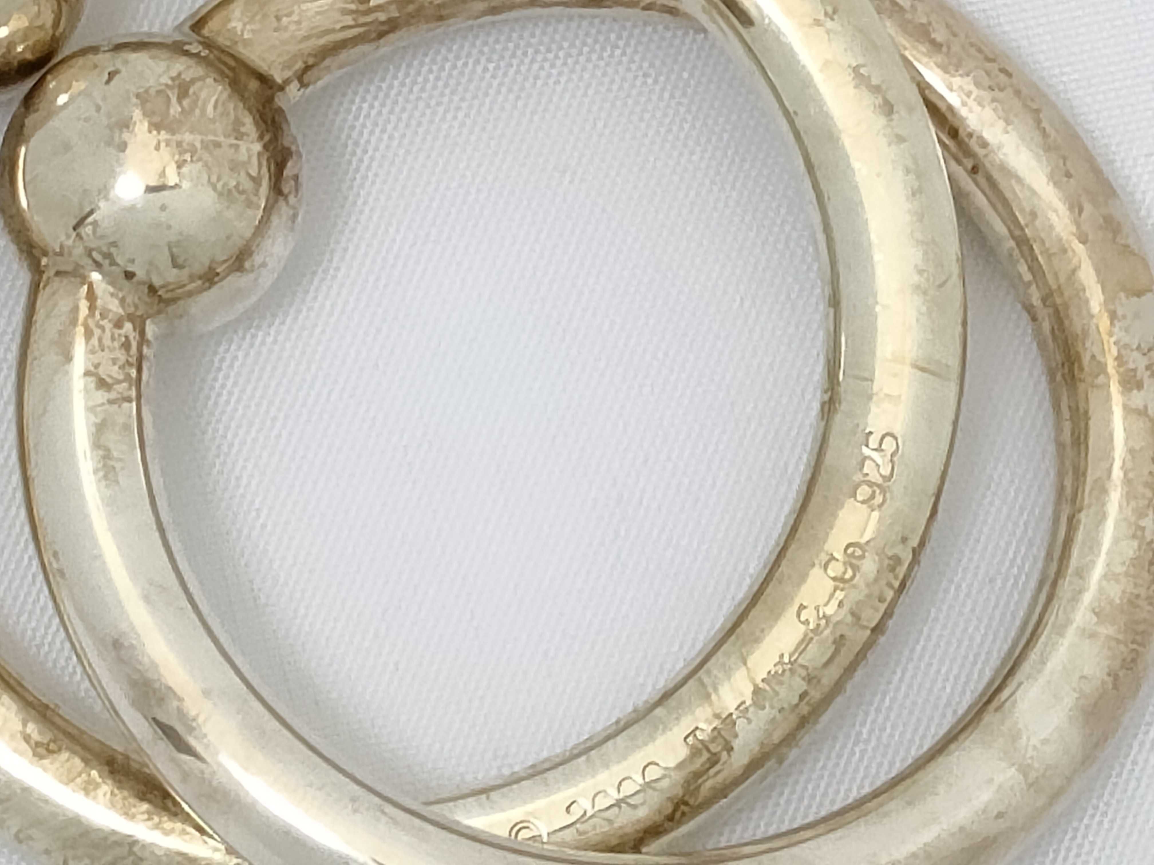 A Pair of Tiffany and Co. Sterling Silver Interlocking Baby Teething Rings