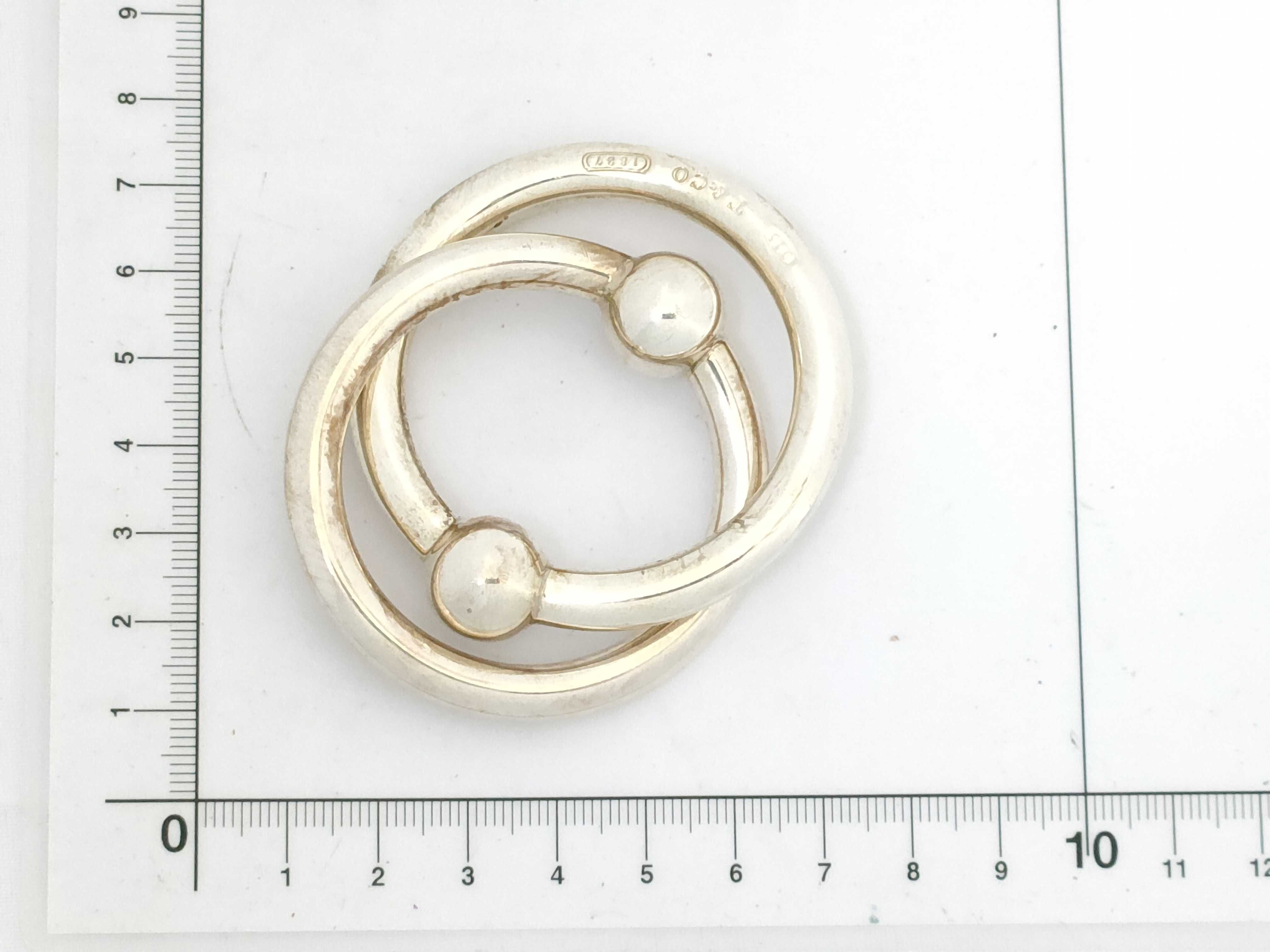 A Pair of Tiffany and Co. Sterling Silver Interlocking Baby Teething Rings