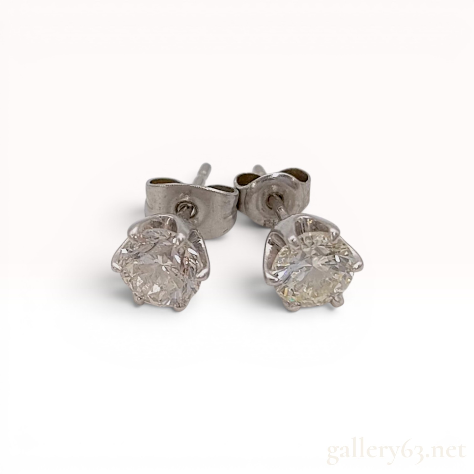 A Pair of 1.5ctw Platinum and Round Brilliant Cut Colorless Natural Diamond Stud Earrings