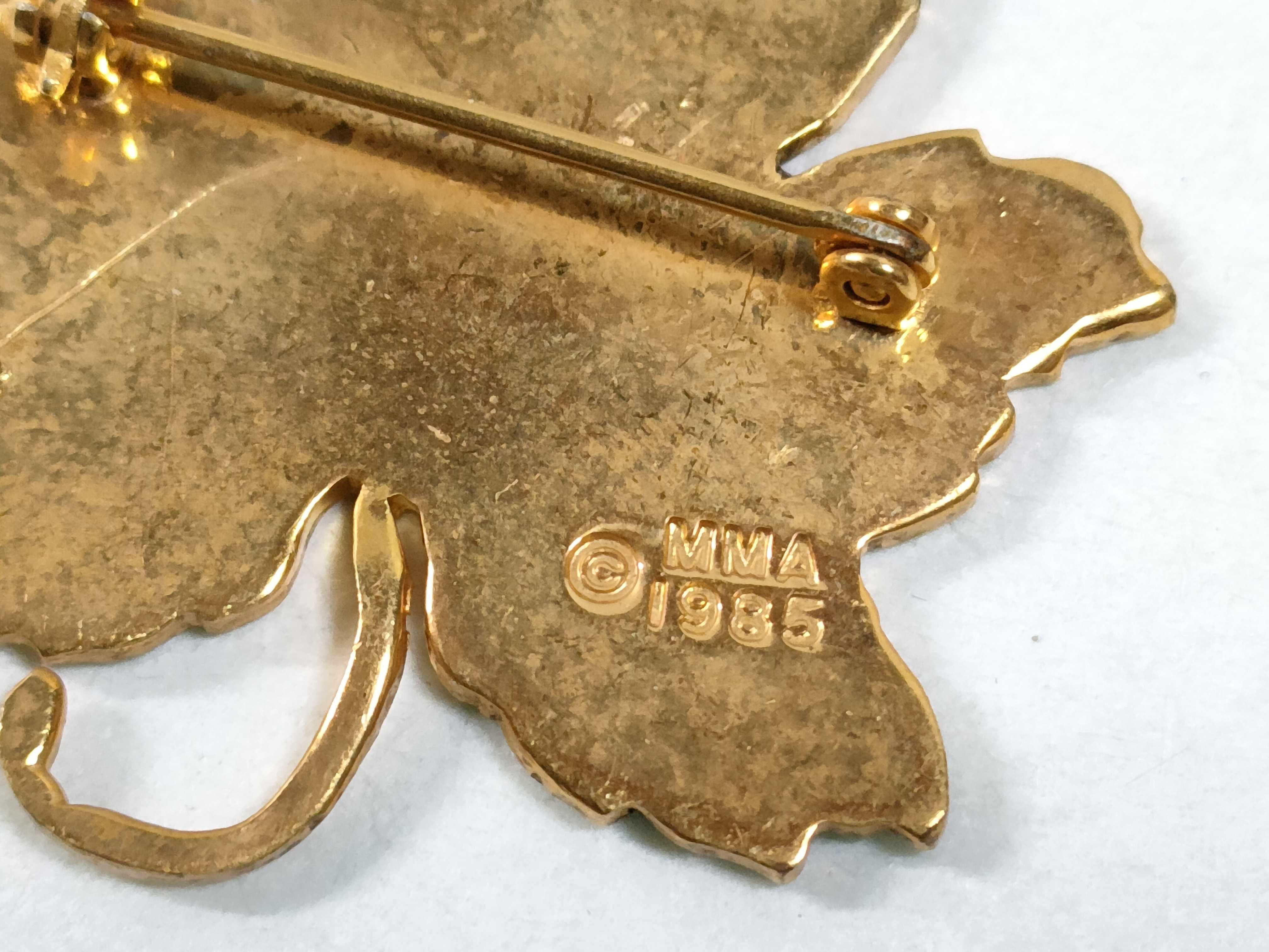 Two Metropolitan Museum of Art MMA Gold-Tone and Enamel Maple Leaf Brooches