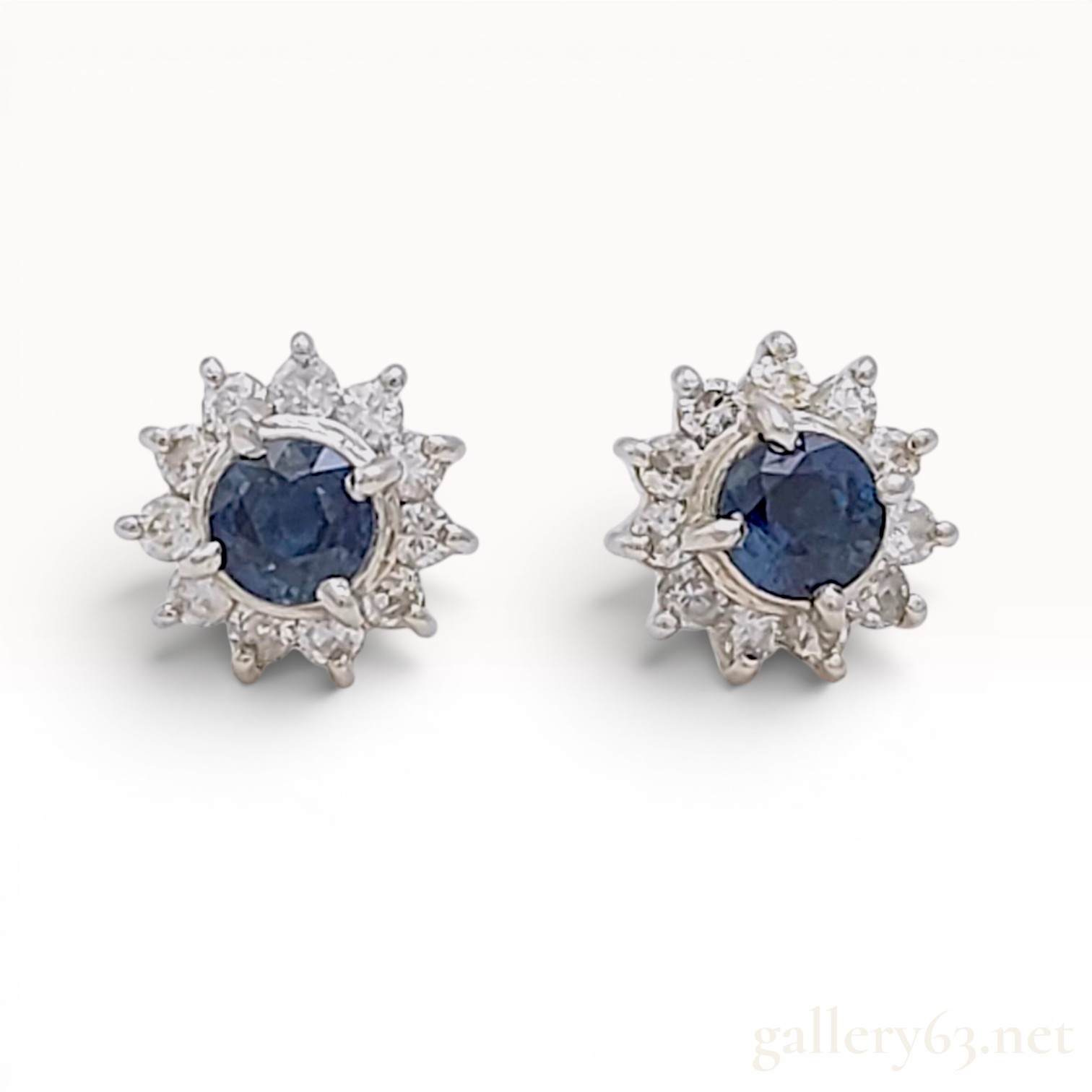 A Pair of Platinum, Sapphire, and Diamond Halo Stud Earrings