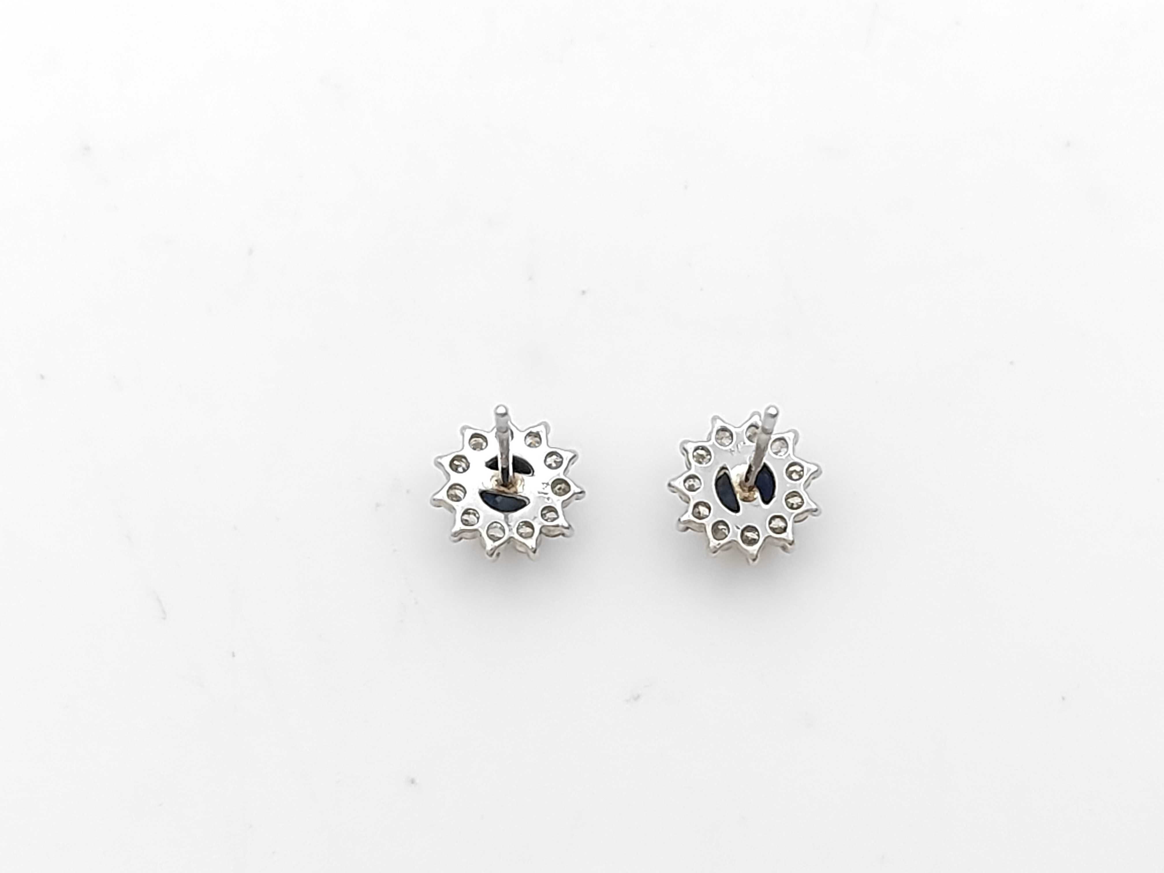 A Pair of Platinum, Sapphire, and Diamond Halo Stud Earrings