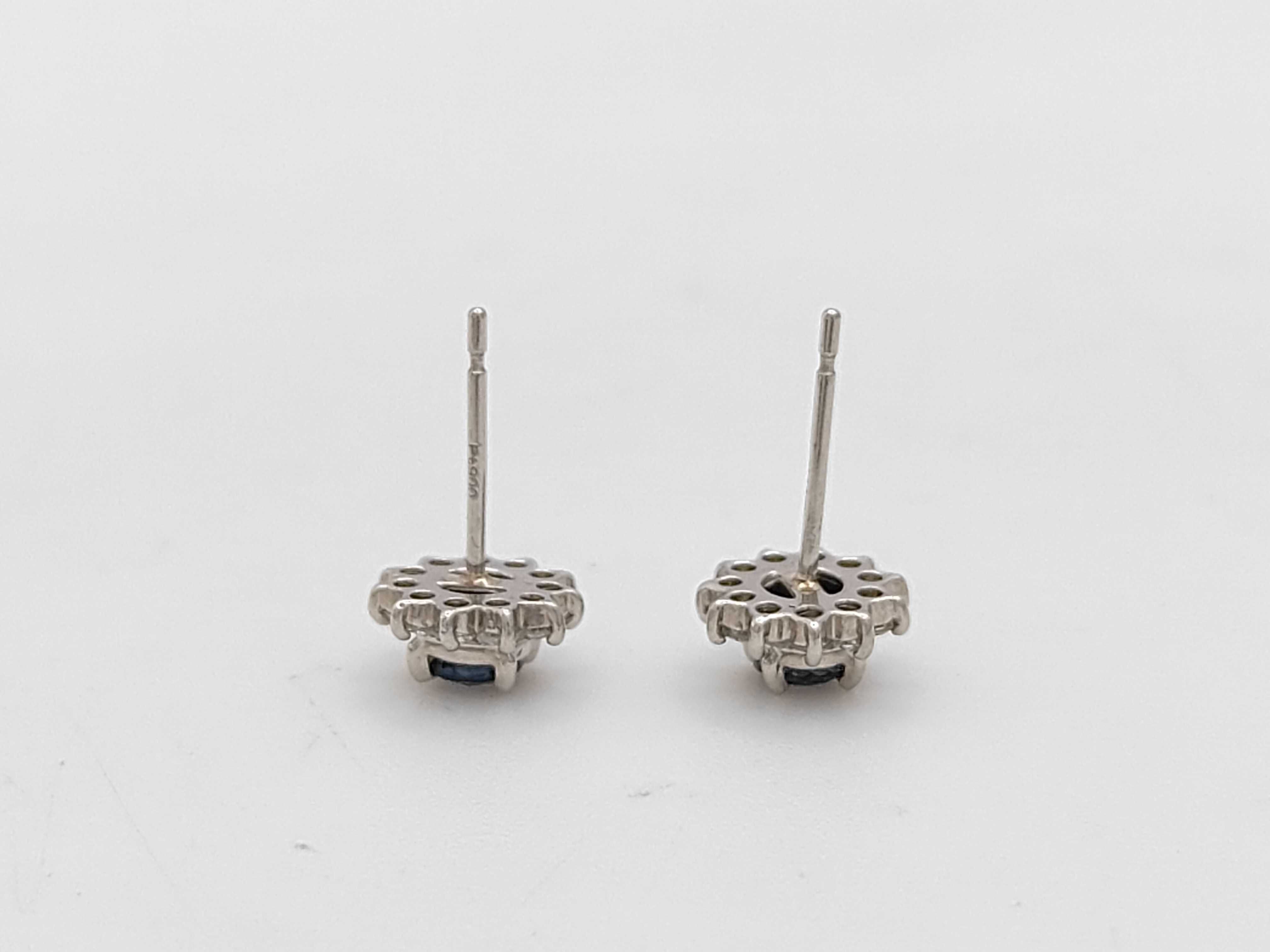 A Pair of Platinum, Sapphire, and Diamond Halo Stud Earrings