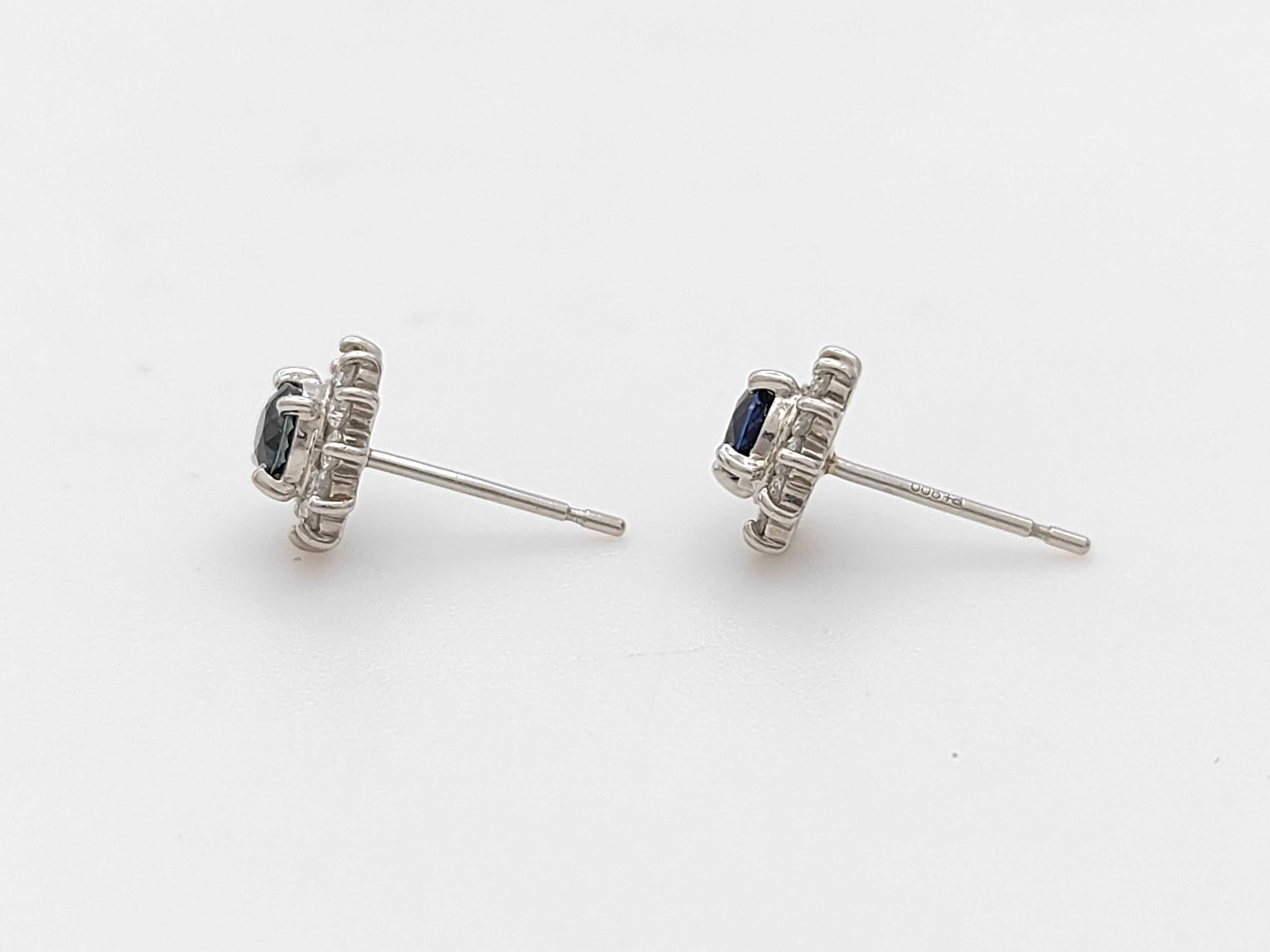A Pair of Platinum, Sapphire, and Diamond Halo Stud Earrings