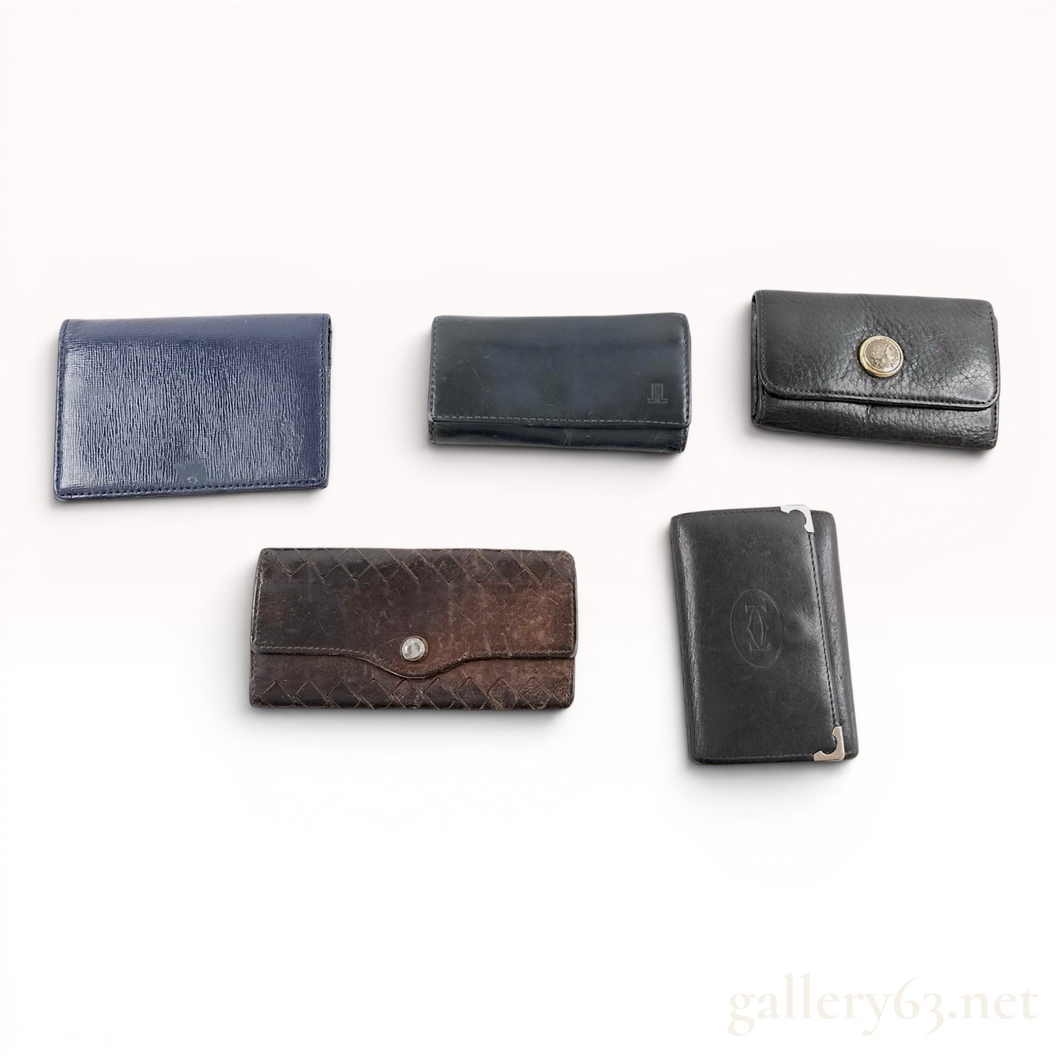 A Collection of Five Designer Leather Key Cases - Cartier, Bvlgari, Bottega Veneta, and Lanvin