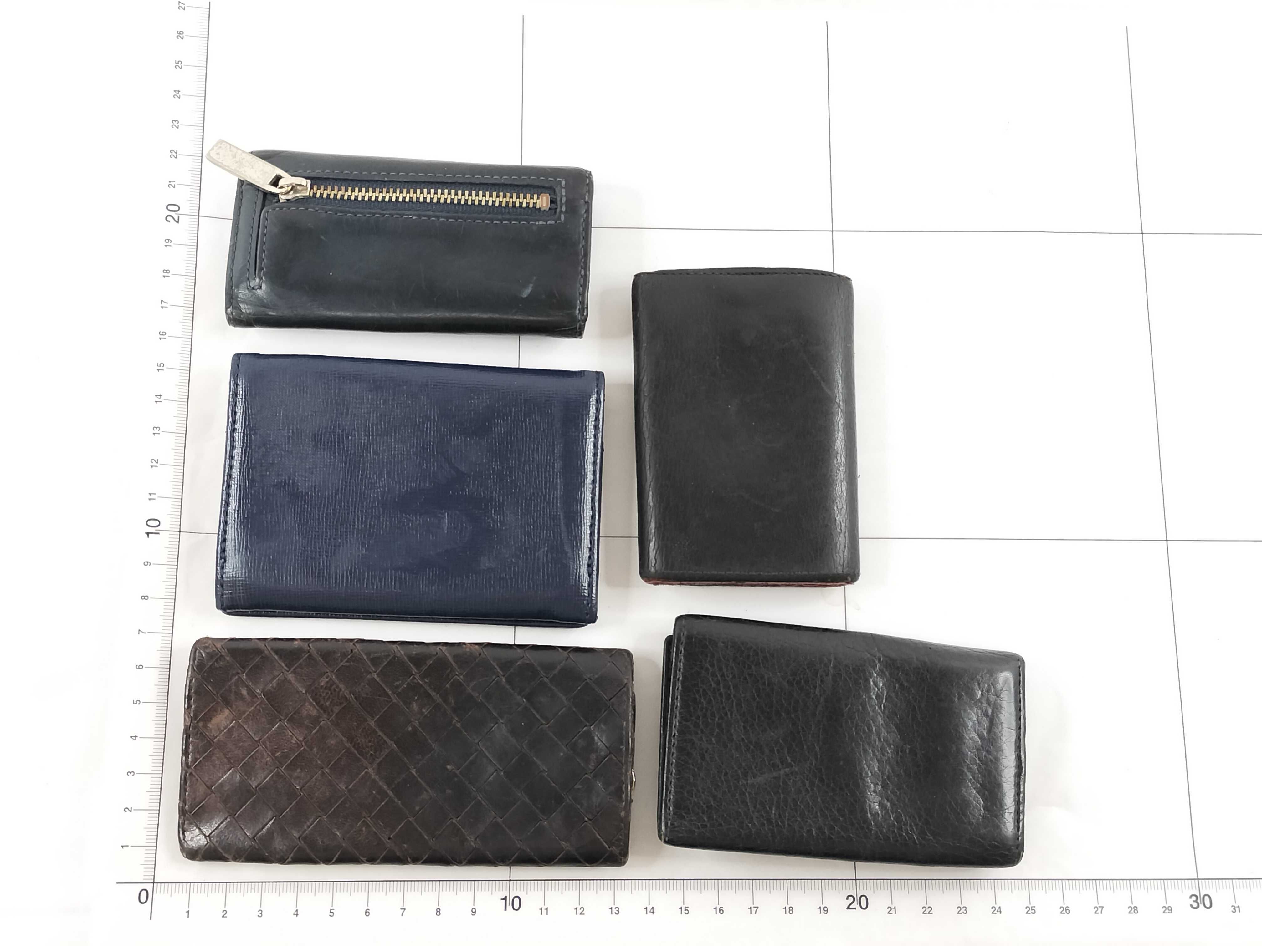 A Collection of Five Designer Leather Key Cases - Cartier, Bvlgari, Bottega Veneta, and Lanvin