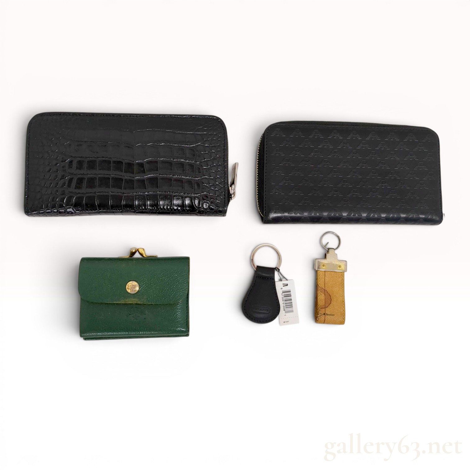 An Assortment of Designer Leather Wallets and Keychains Including Orobianco, Emporio Armani, and Il Bisonte