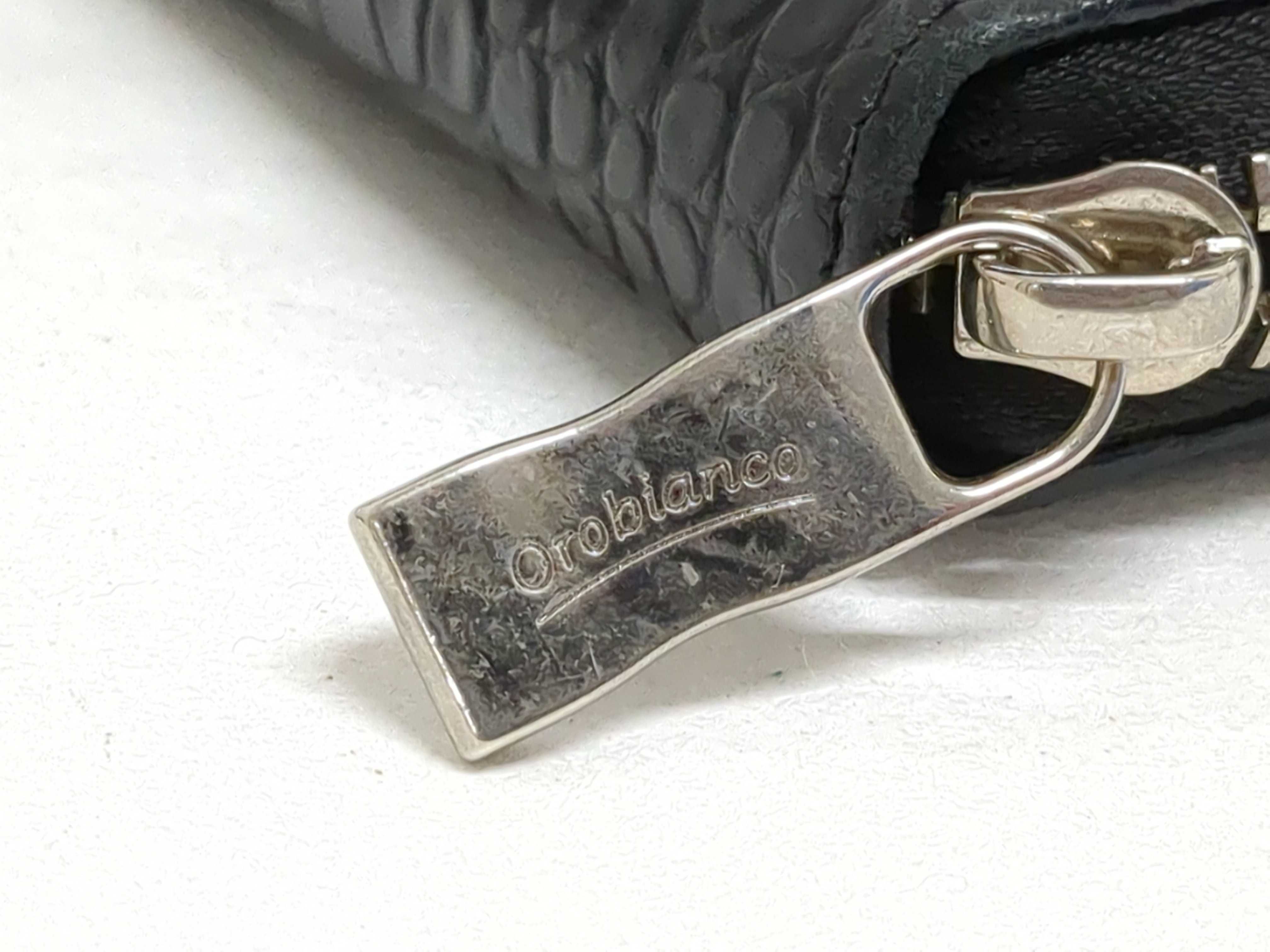 An Assortment of Designer Leather Wallets and Keychains Including Orobianco, Emporio Armani, and Il Bisonte