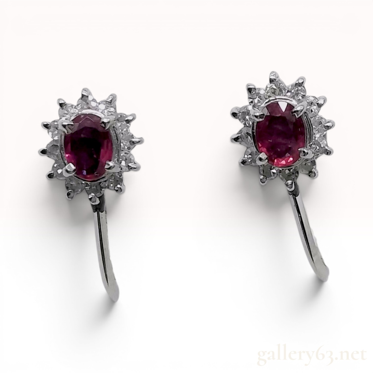 A Pair of Platinum, Ruby, and Diamond Cluster Screw-Back Earrings