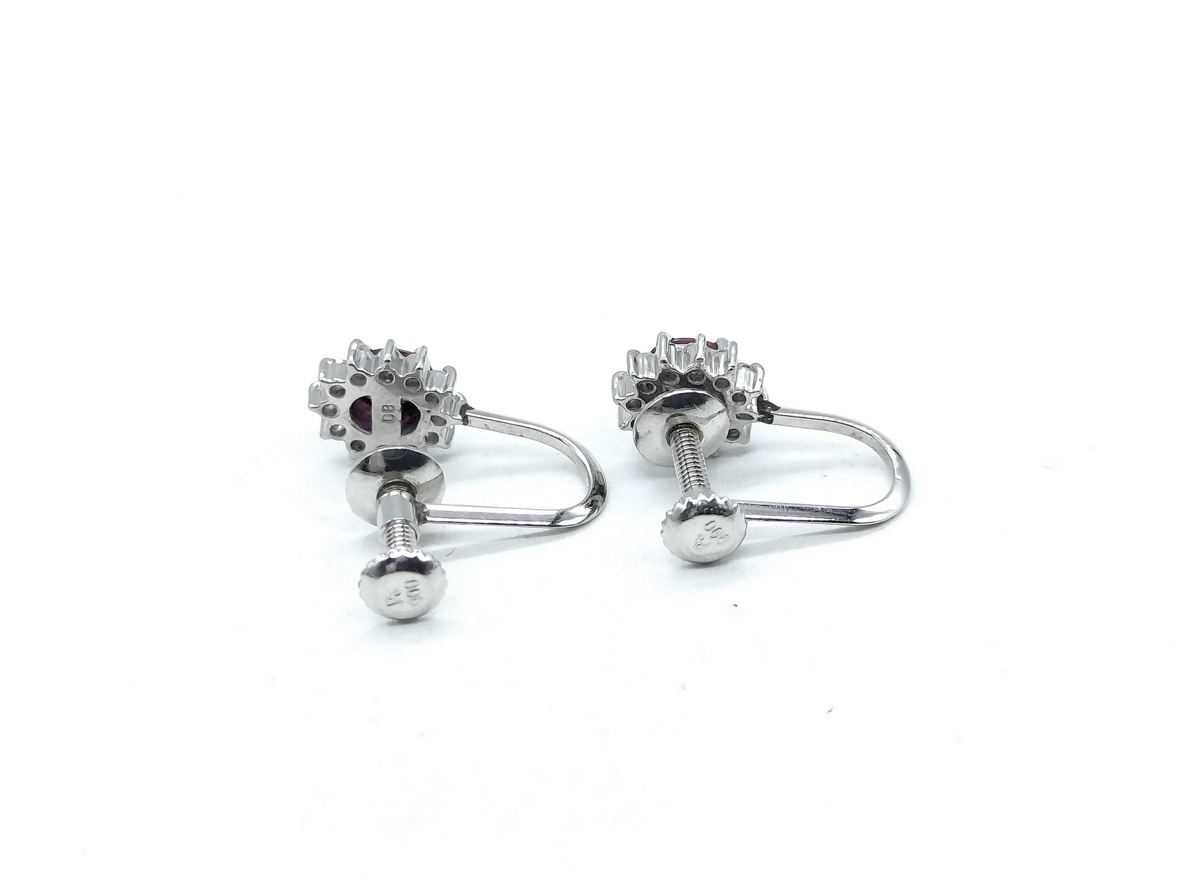 A Pair of Platinum, Ruby, and Diamond Cluster Screw-Back Earrings