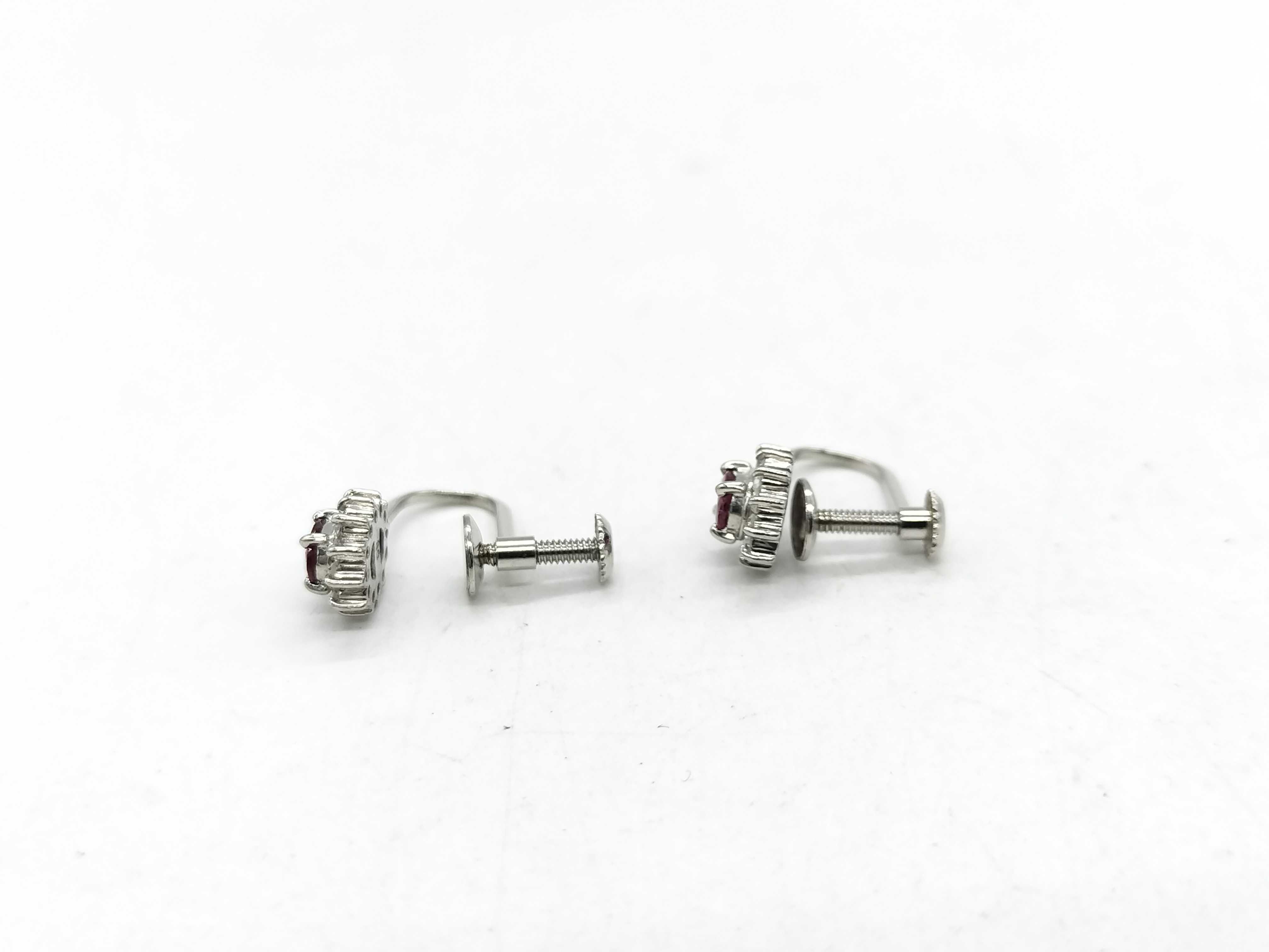 A Pair of Platinum, Ruby, and Diamond Cluster Screw-Back Earrings