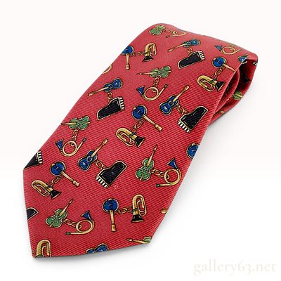Chanel Red Silk Novelty Print Musical Instrument Necktie. A vintage silk necktie by Chanel 
