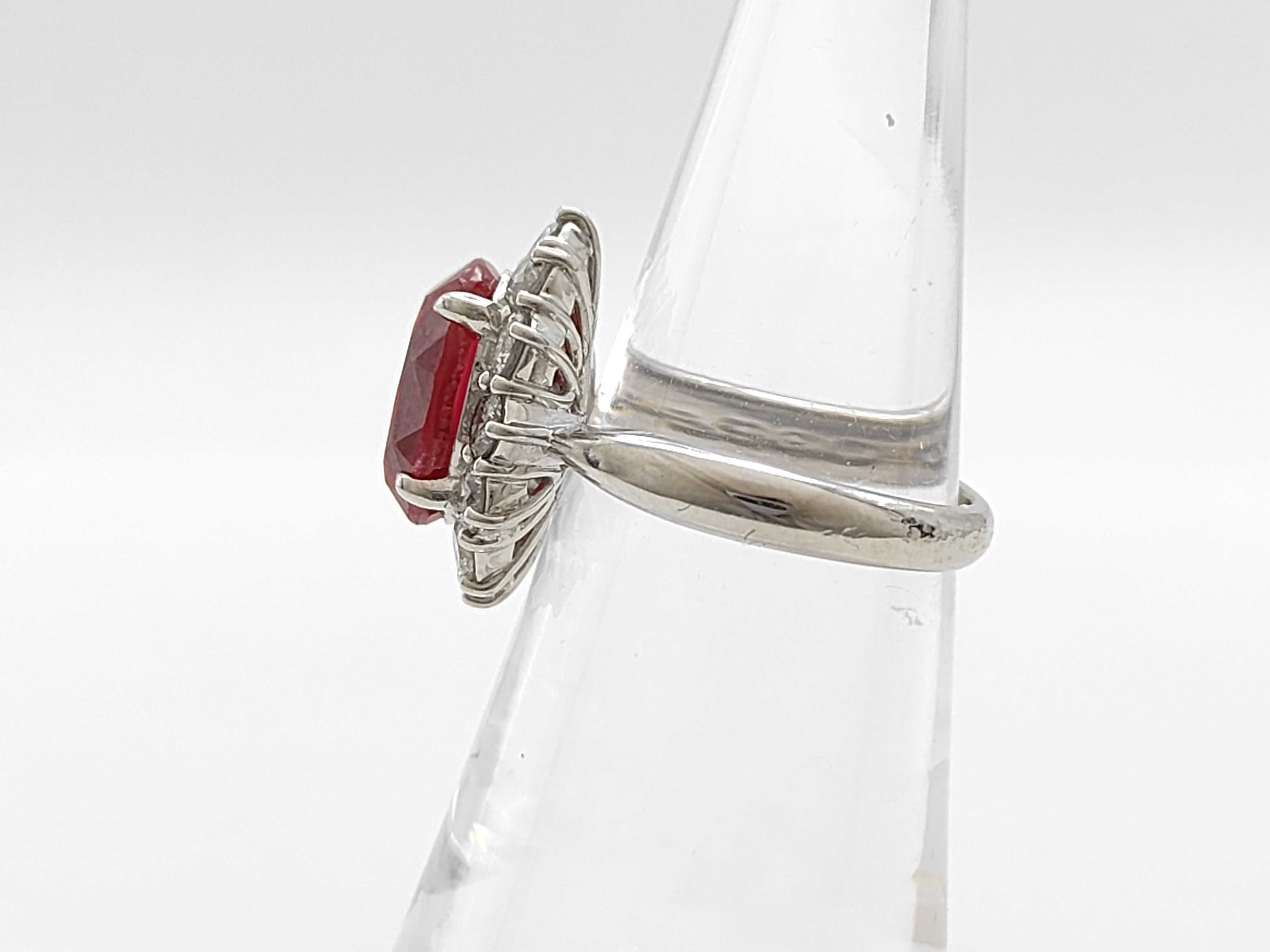 A 5.30ct Ruby and 1.04ctw Diamond Halo Ring in Platinum
