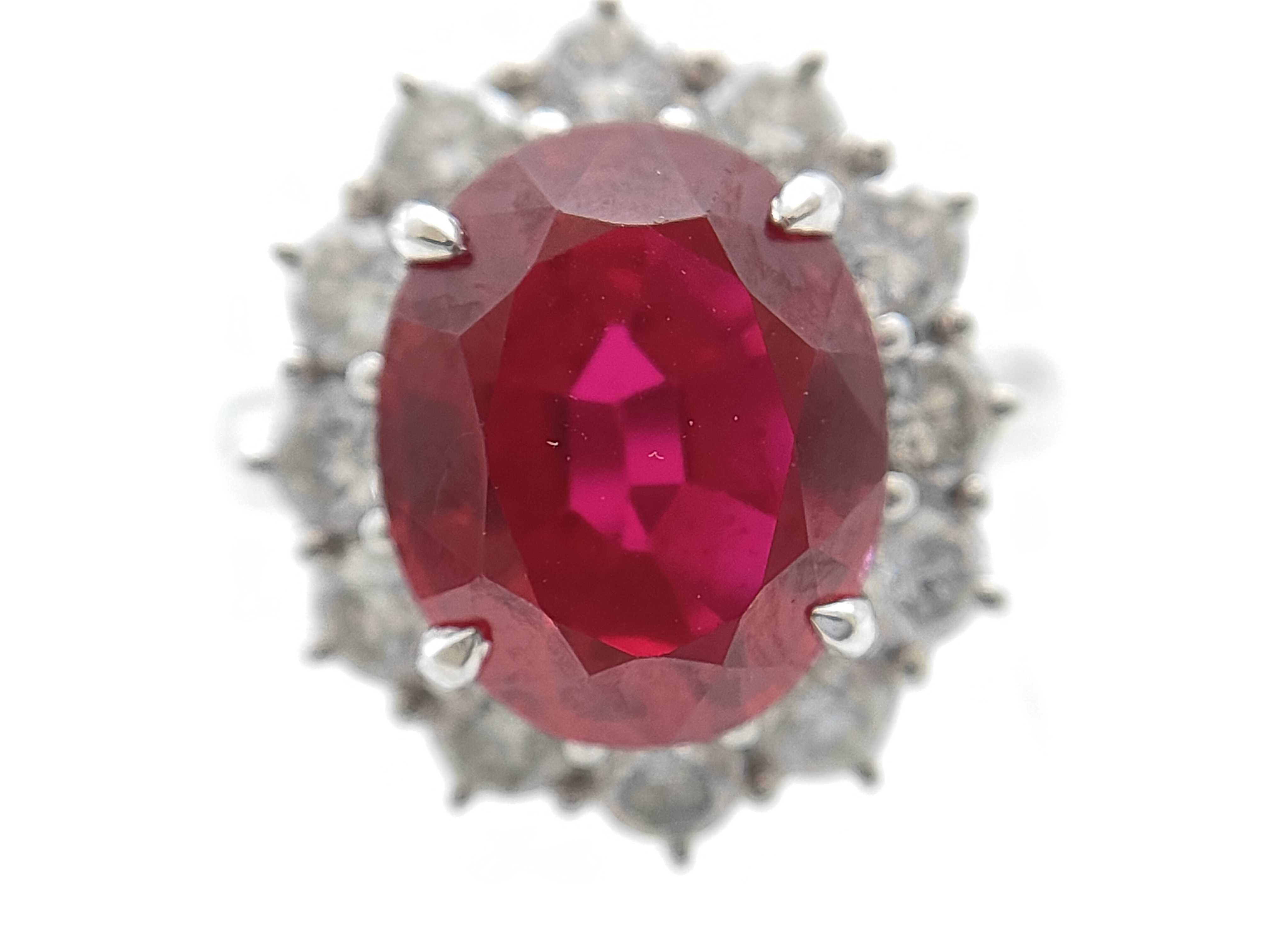 A 5.30ct Ruby and 1.04ctw Diamond Halo Ring in Platinum
