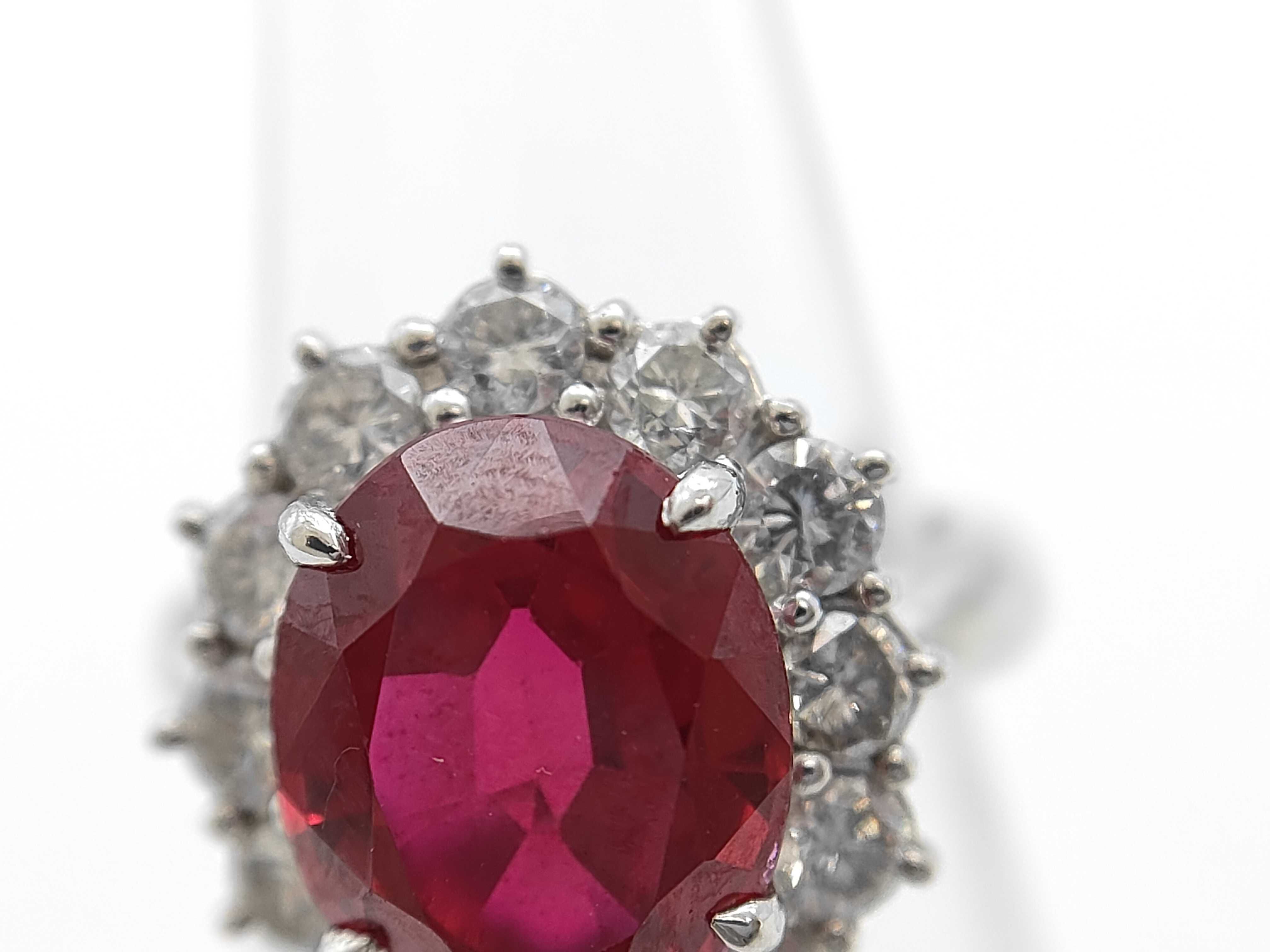 A 5.30ct Ruby and 1.04ctw Diamond Halo Ring in Platinum