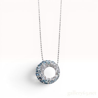 An 18 Karat White Gold 0.40 Carat Sapphire and Diamond Ombre Circle Pendant Necklace. This 18 