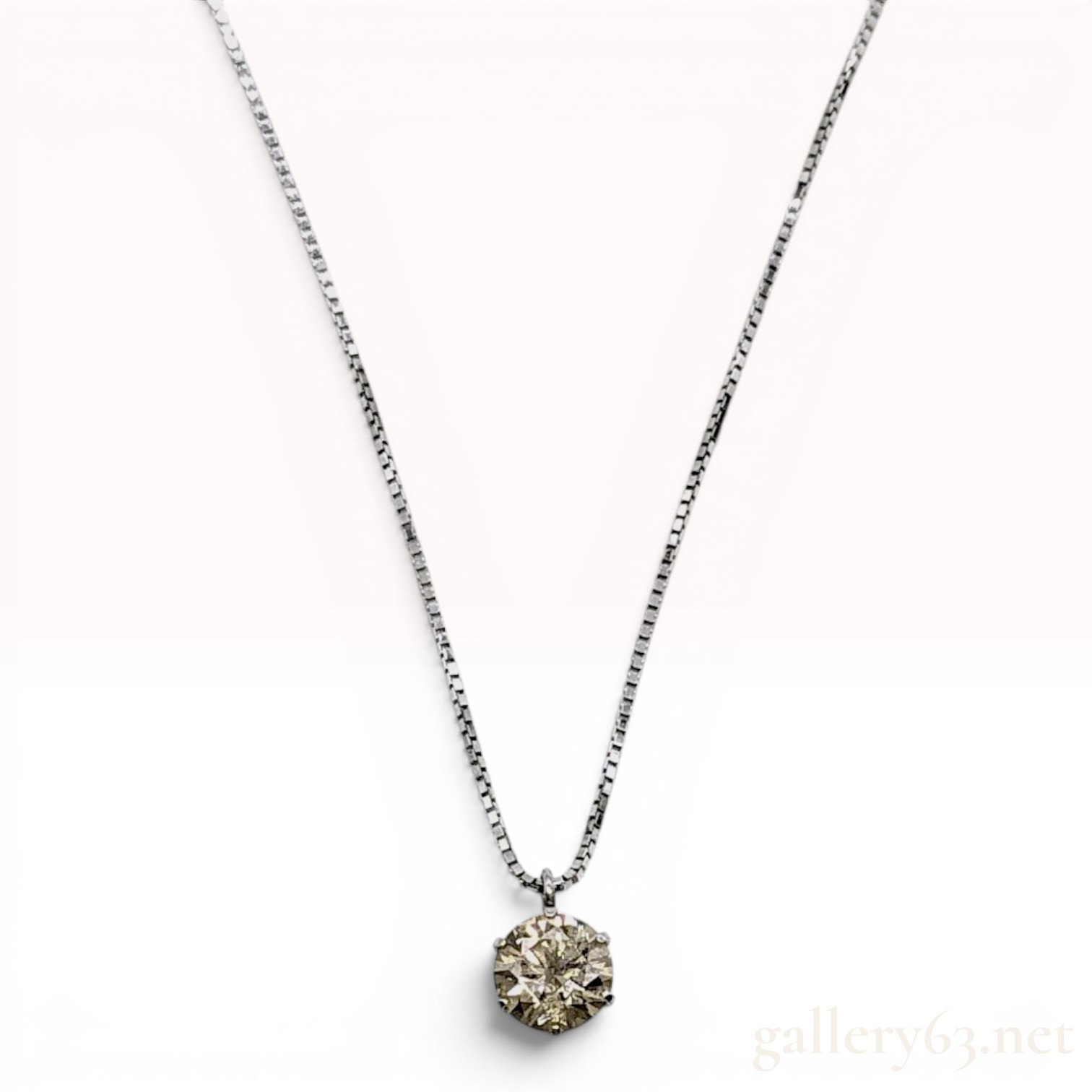 A Solitaire Diamond Pendant Necklace in Platinum and 18-Karat White Gold