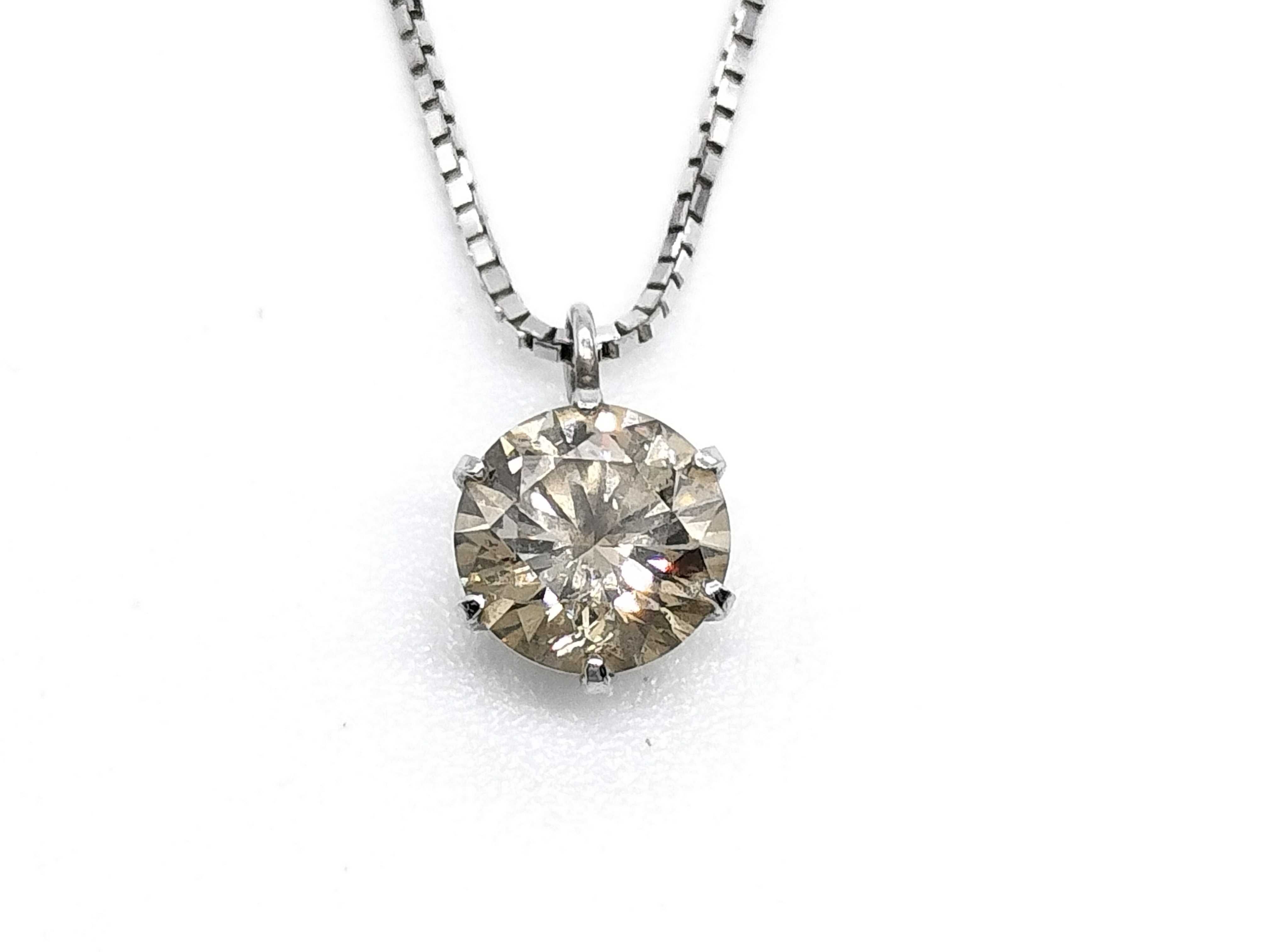 A Solitaire Diamond Pendant Necklace in Platinum and 18-Karat White Gold