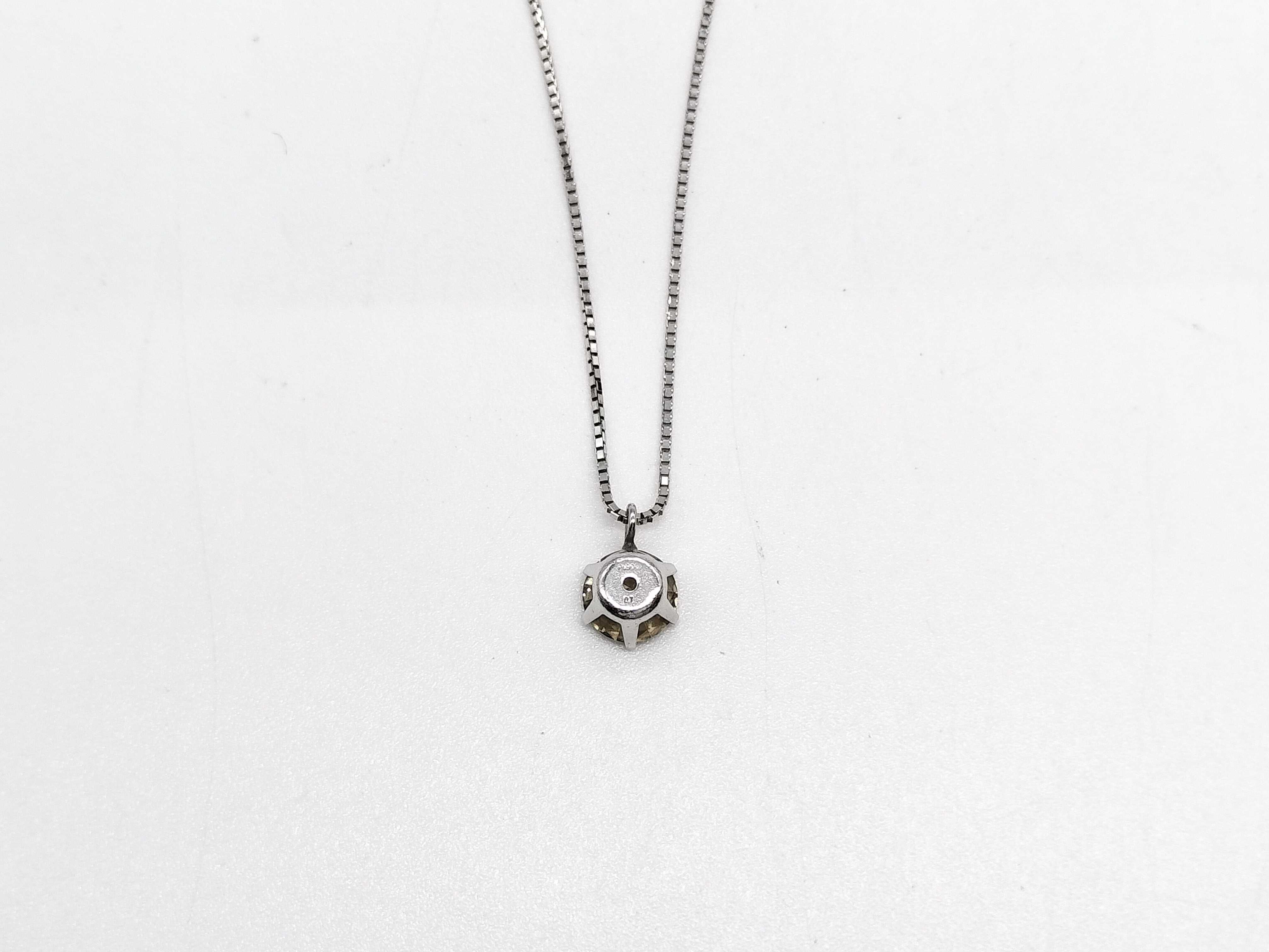 A Solitaire Diamond Pendant Necklace in Platinum and 18-Karat White Gold