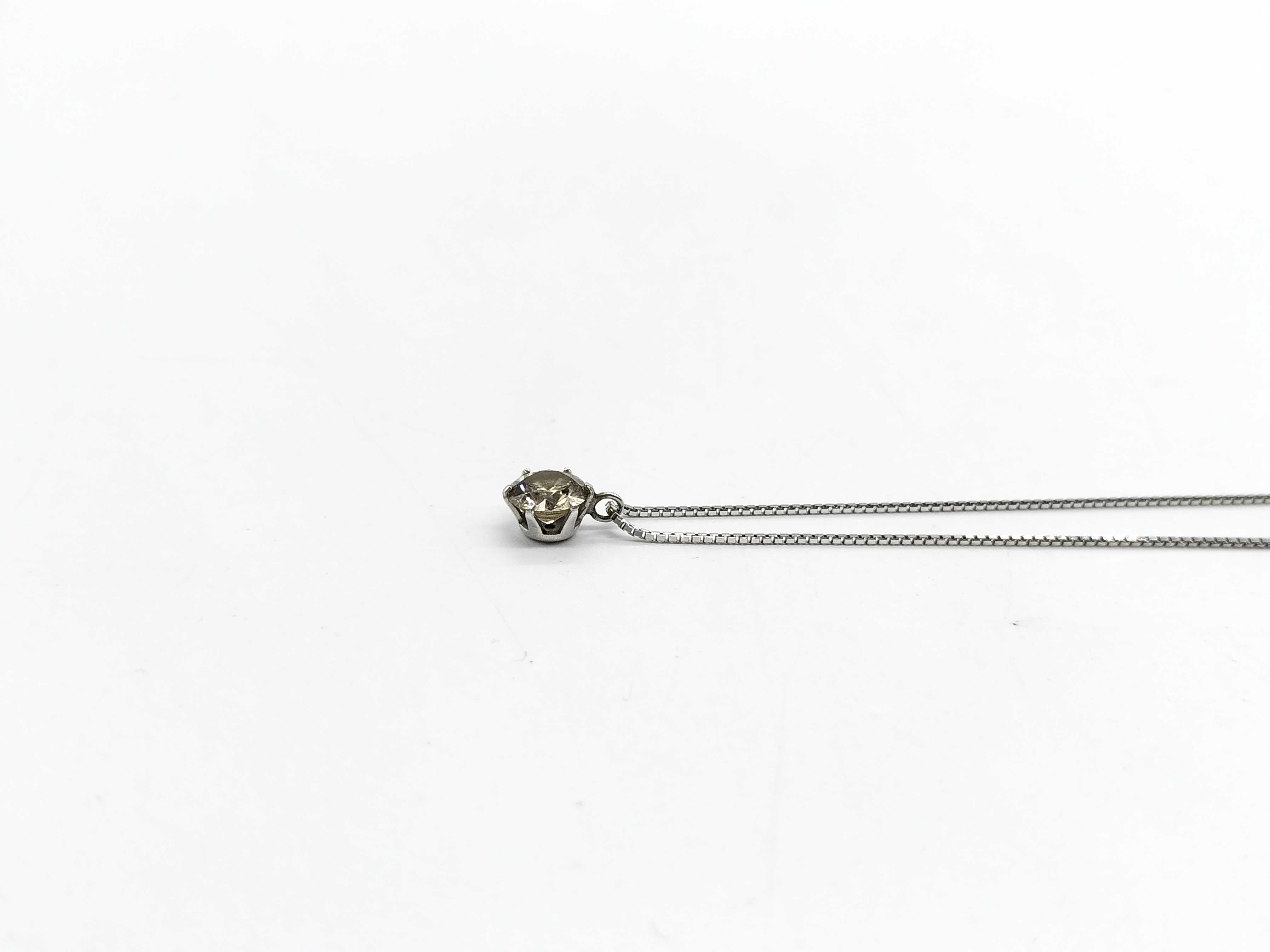 A Solitaire Diamond Pendant Necklace in Platinum and 18-Karat White Gold