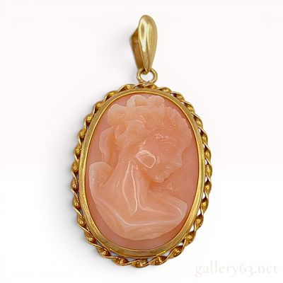 An 18 Karat Yellow Gold and Carved Shell Cameo Pendant. This oval pendant features a high-relief 
