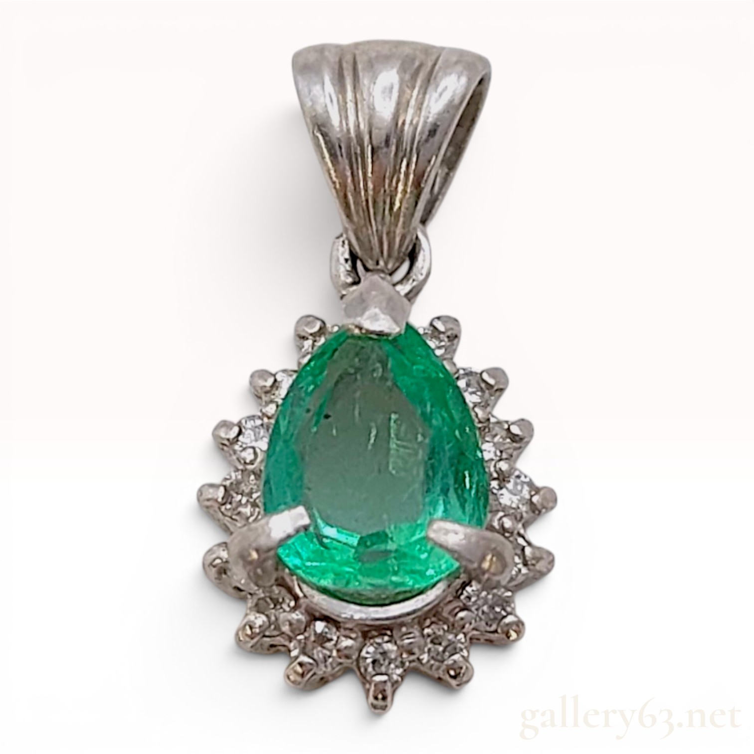 A Platinum Pear-Cut Emerald and Diamond Halo Pendant