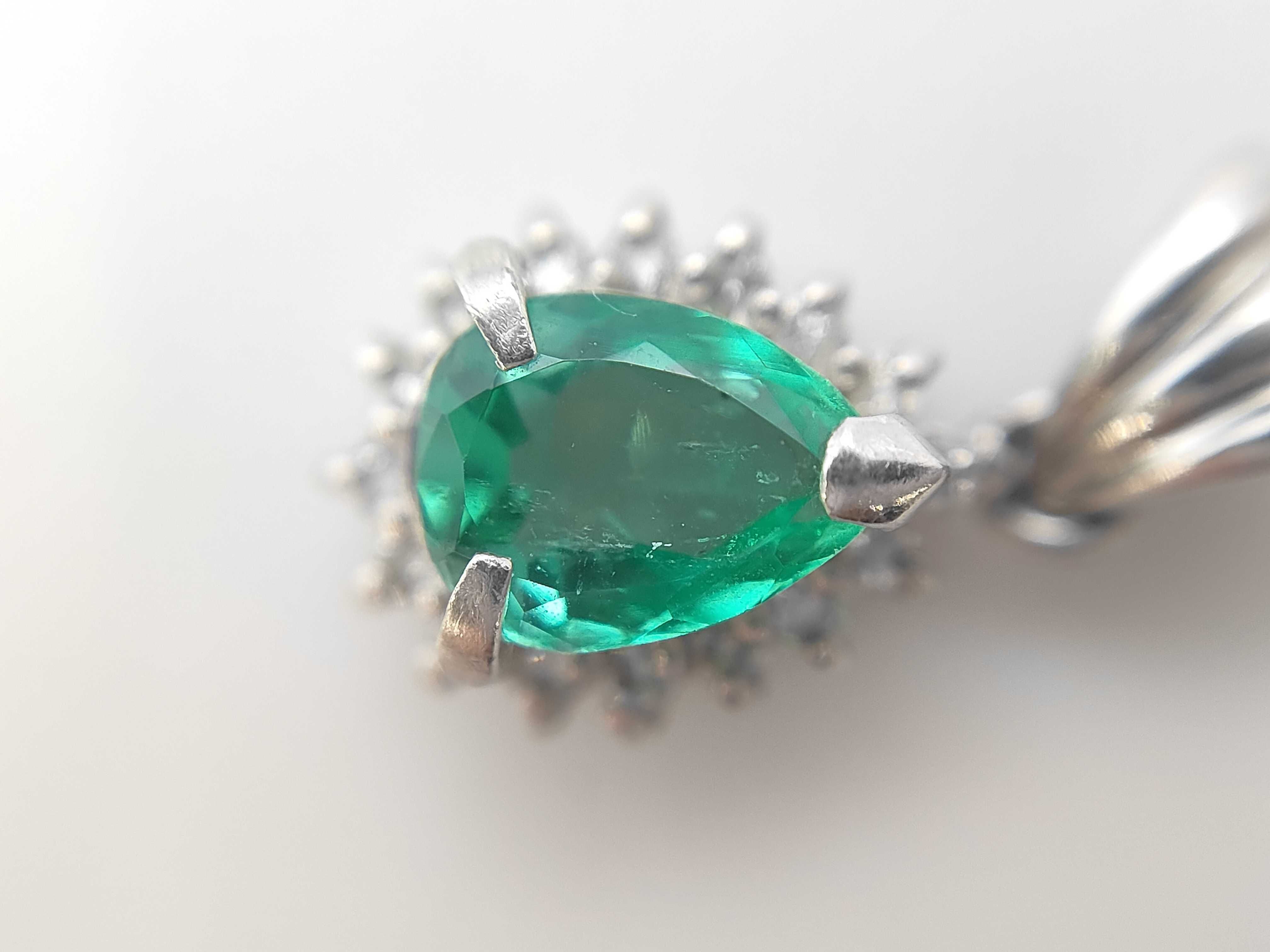 A Platinum Pear-Cut Emerald and Diamond Halo Pendant