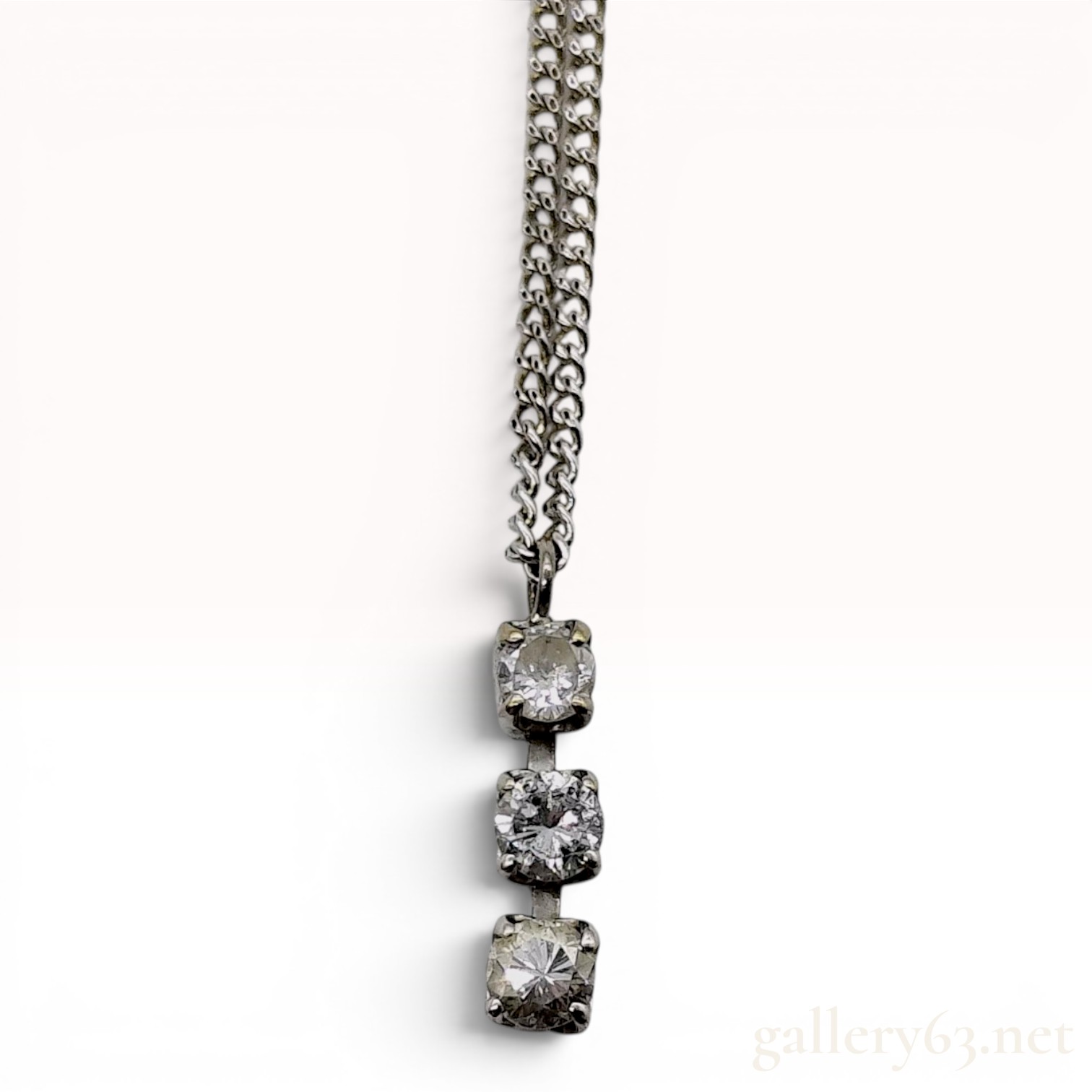 An 18 Karat White Gold and Diamond Three Stone Drop Necklace